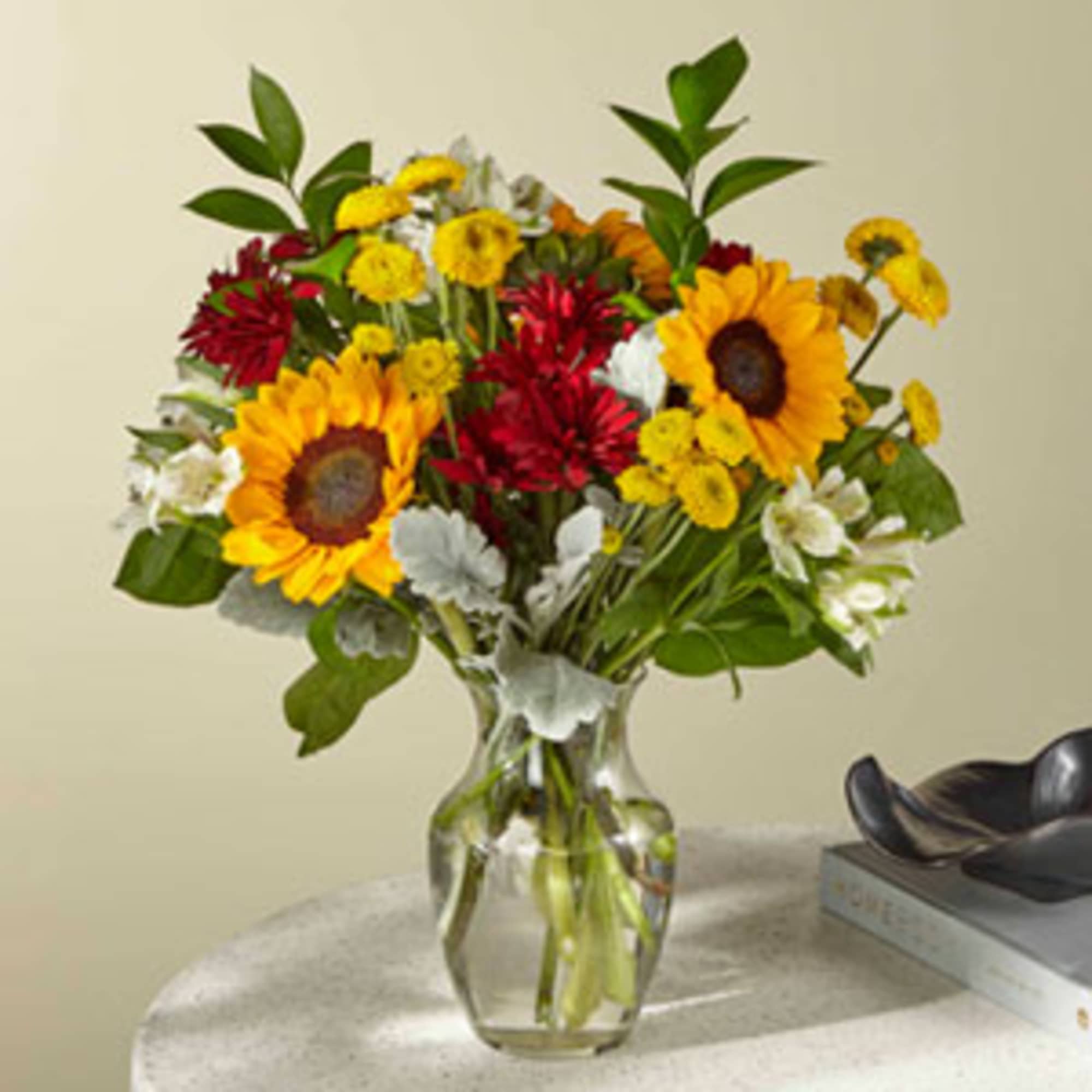Sunflowers and bronze daisy pompons create bold contrast in this eye-catching bucolic