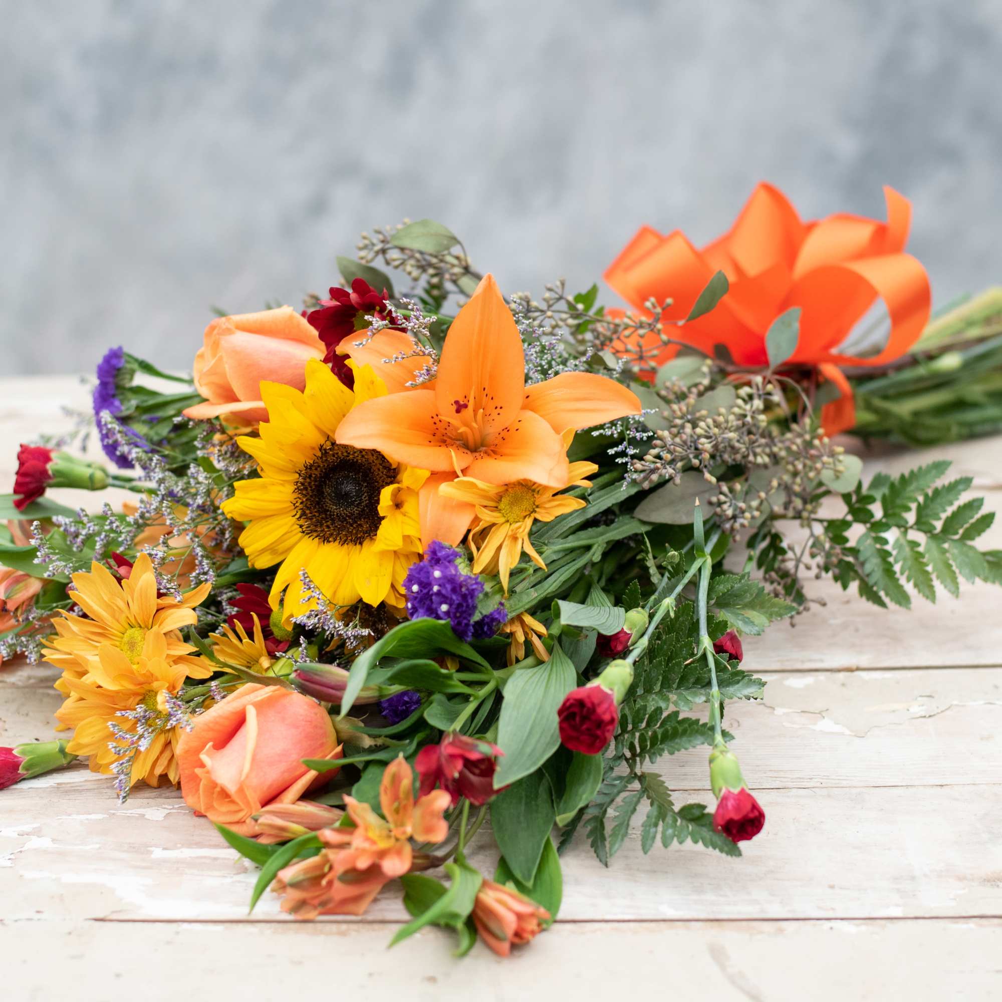 Let our designers choose a variety of seasonal jewel tone blossoms to