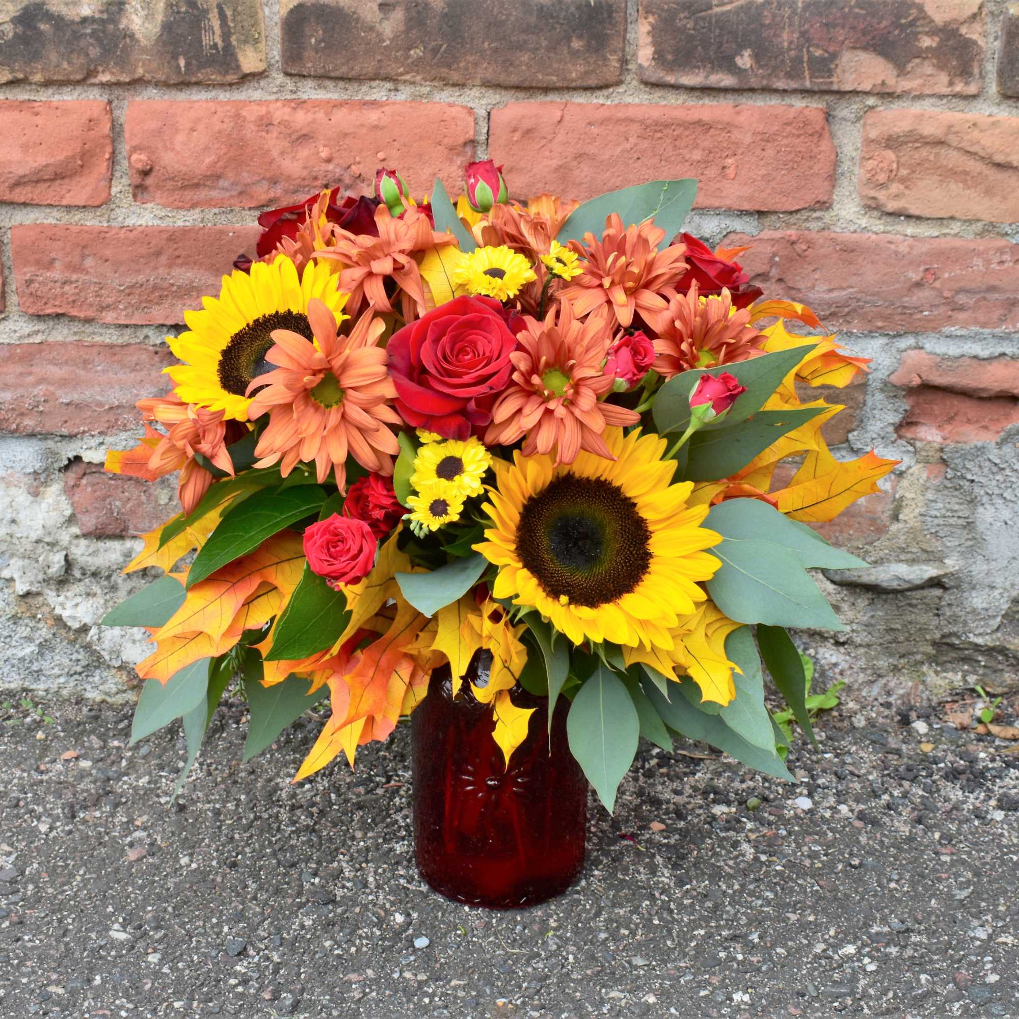 Celebrating the vibrant colors and textures that fall brings, this bouquet is