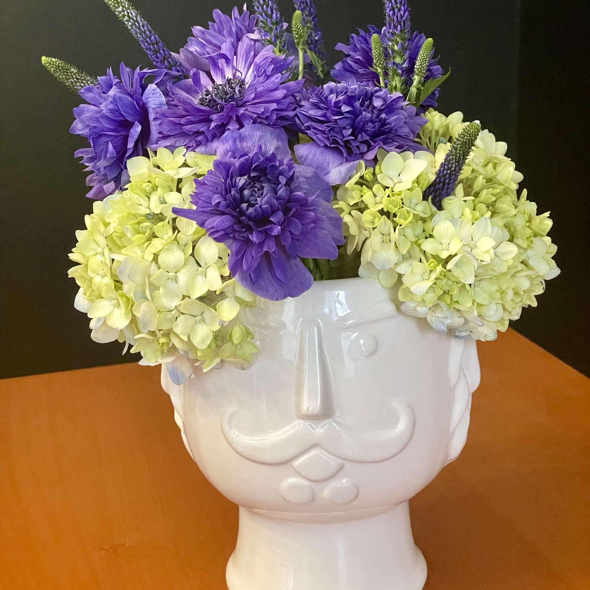 This fun and eye-catching arrangement is designed in a glossy white ceramic