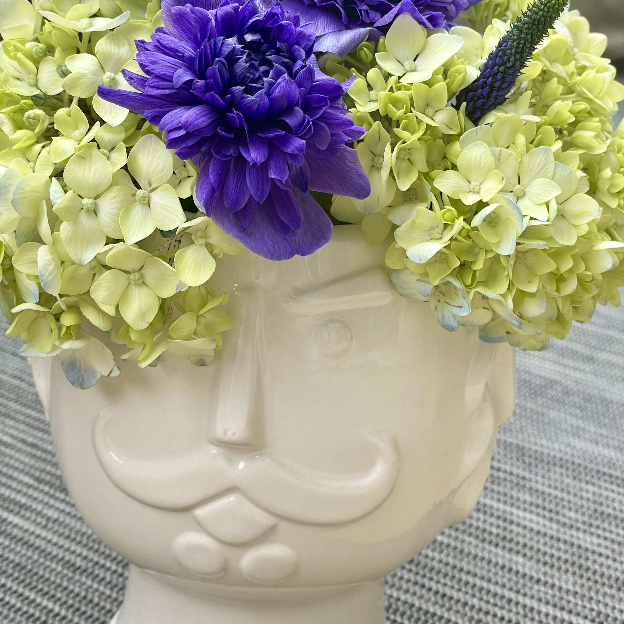 This fun and eye-catching arrangement is designed in a glossy white ceramic