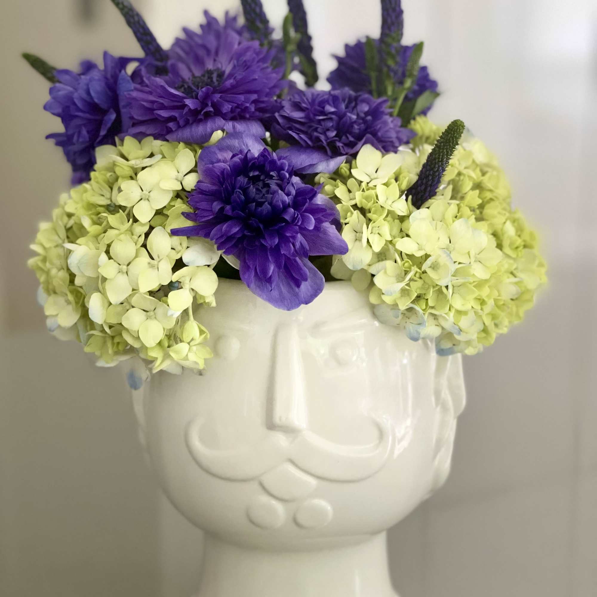 This fun and eye-catching arrangement is designed in a glossy white ceramic