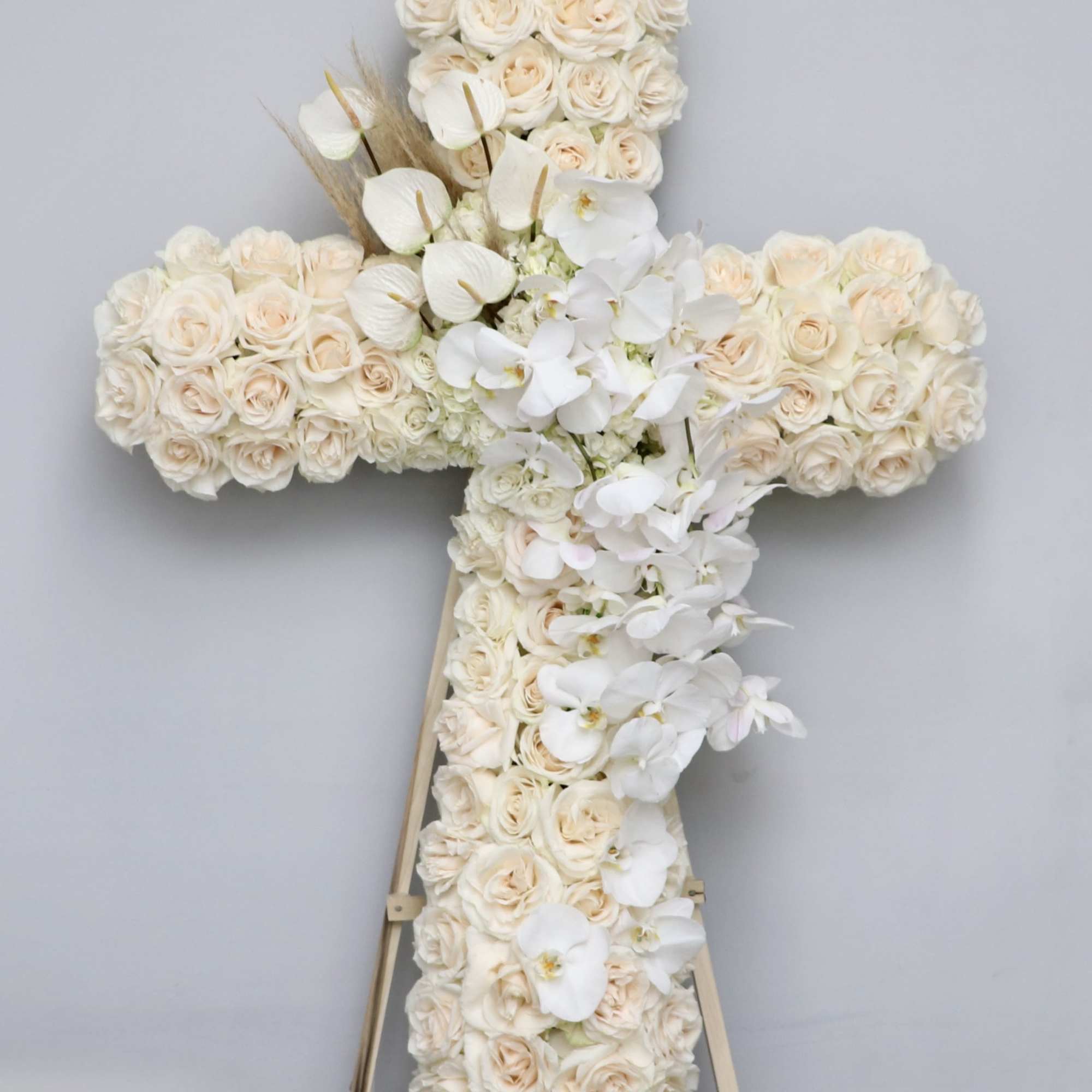 This stunning cross is made with white roses and an all white