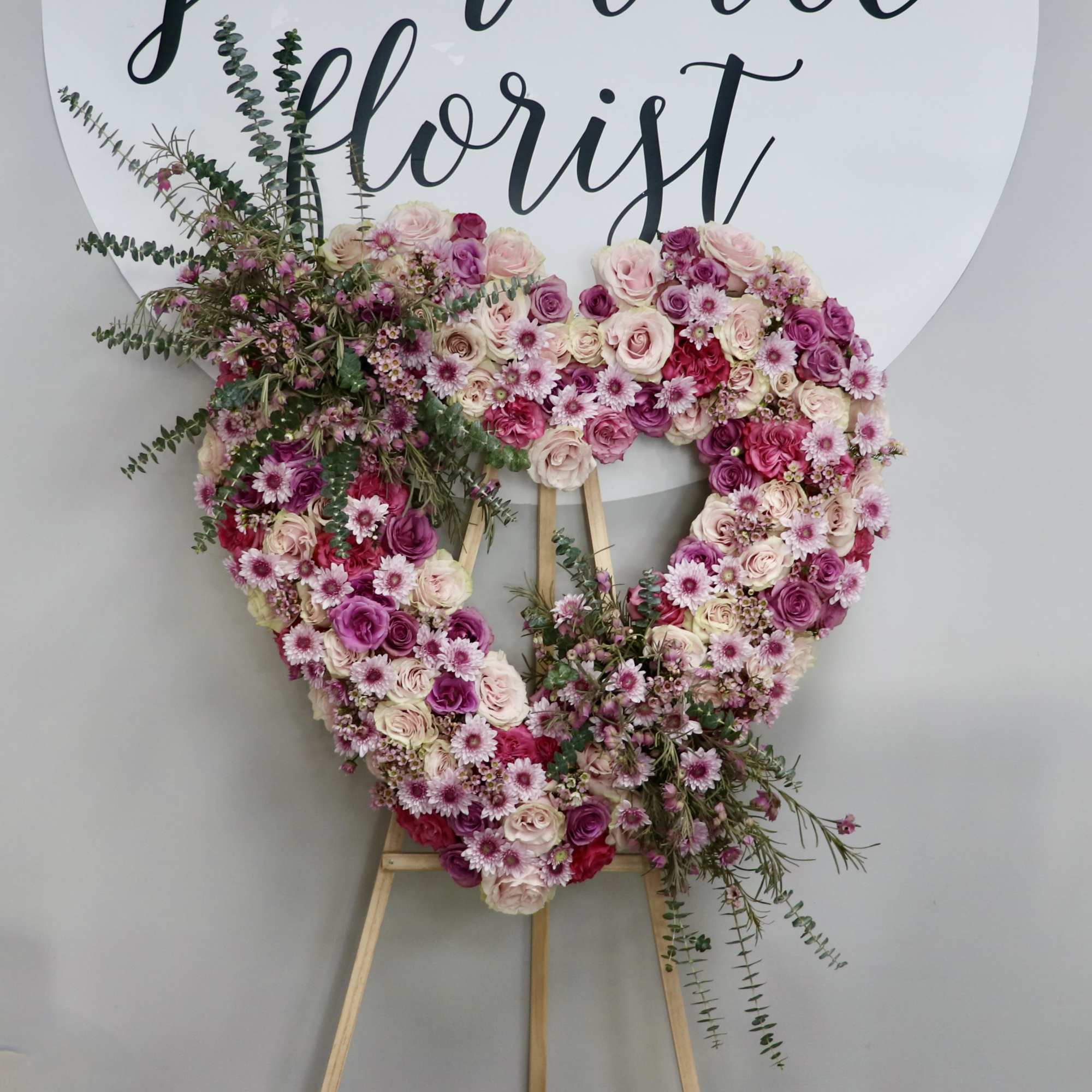 This beautiful heart wreath is made with pink and lavender roses and