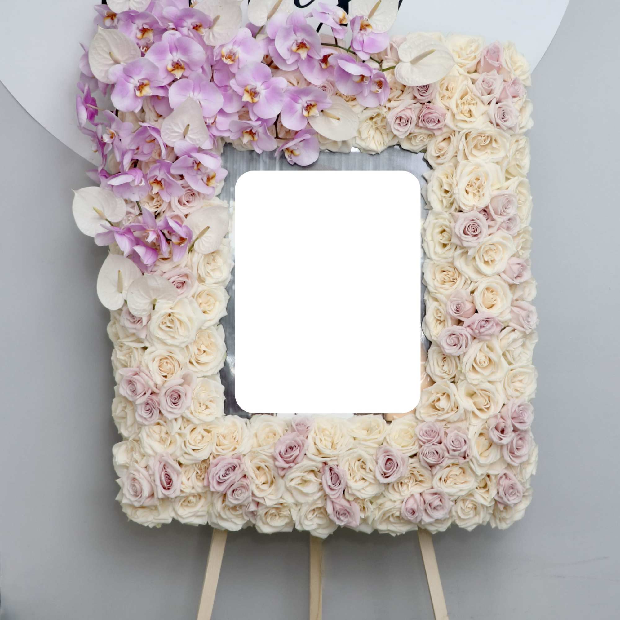 This sympathy frame is made with light pink and white roses and