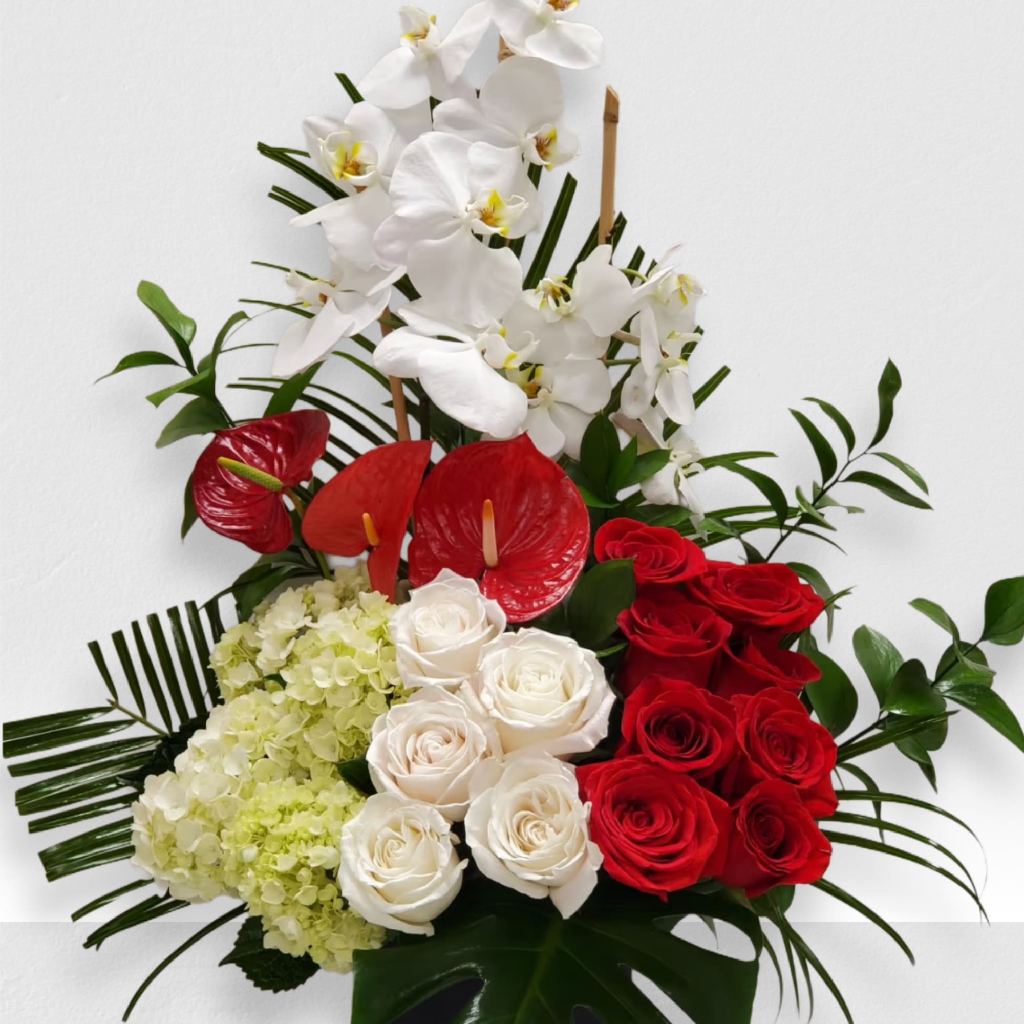 Tropical romance is a beautiful romantic arrangement with orchid, roses, hydrangea and