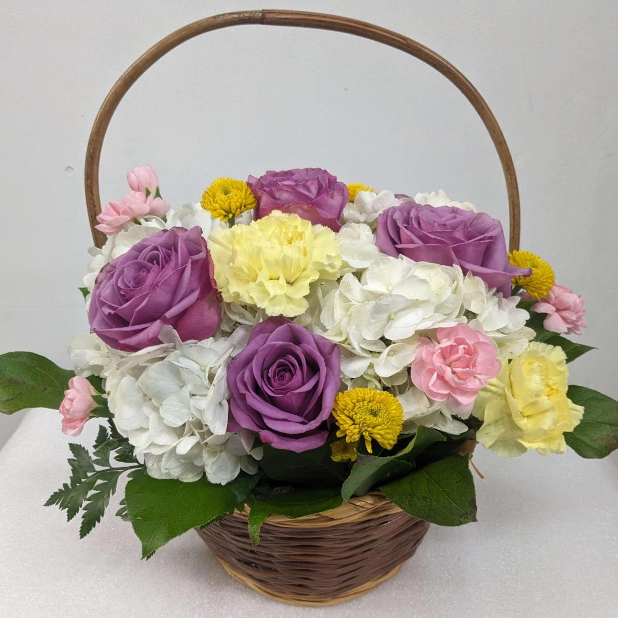 A pastel flowering basket brings peace to any space. Send this beautiful