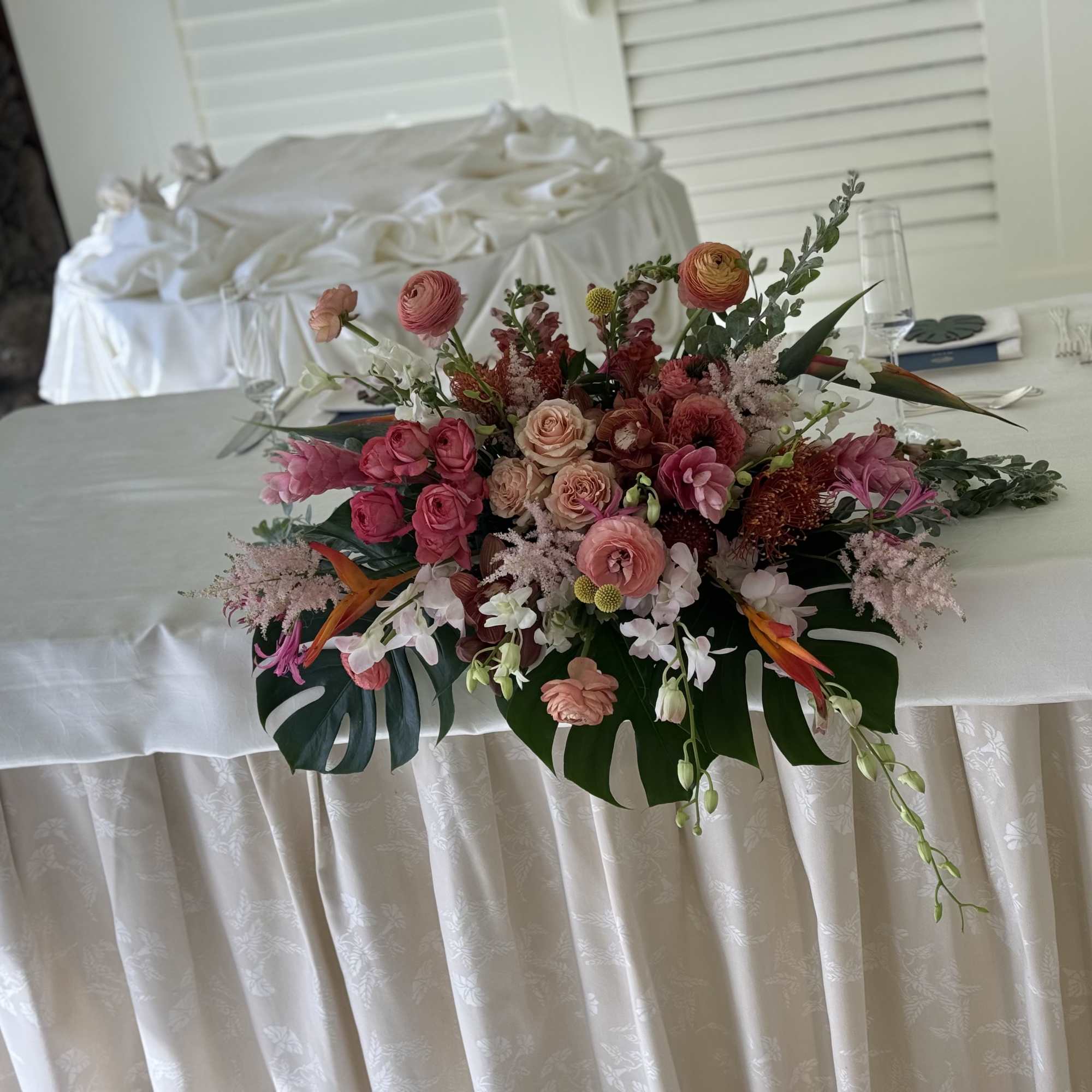 Embrace the spirit of Hawaii with this stunning pink tropical centerpiece. Expertly