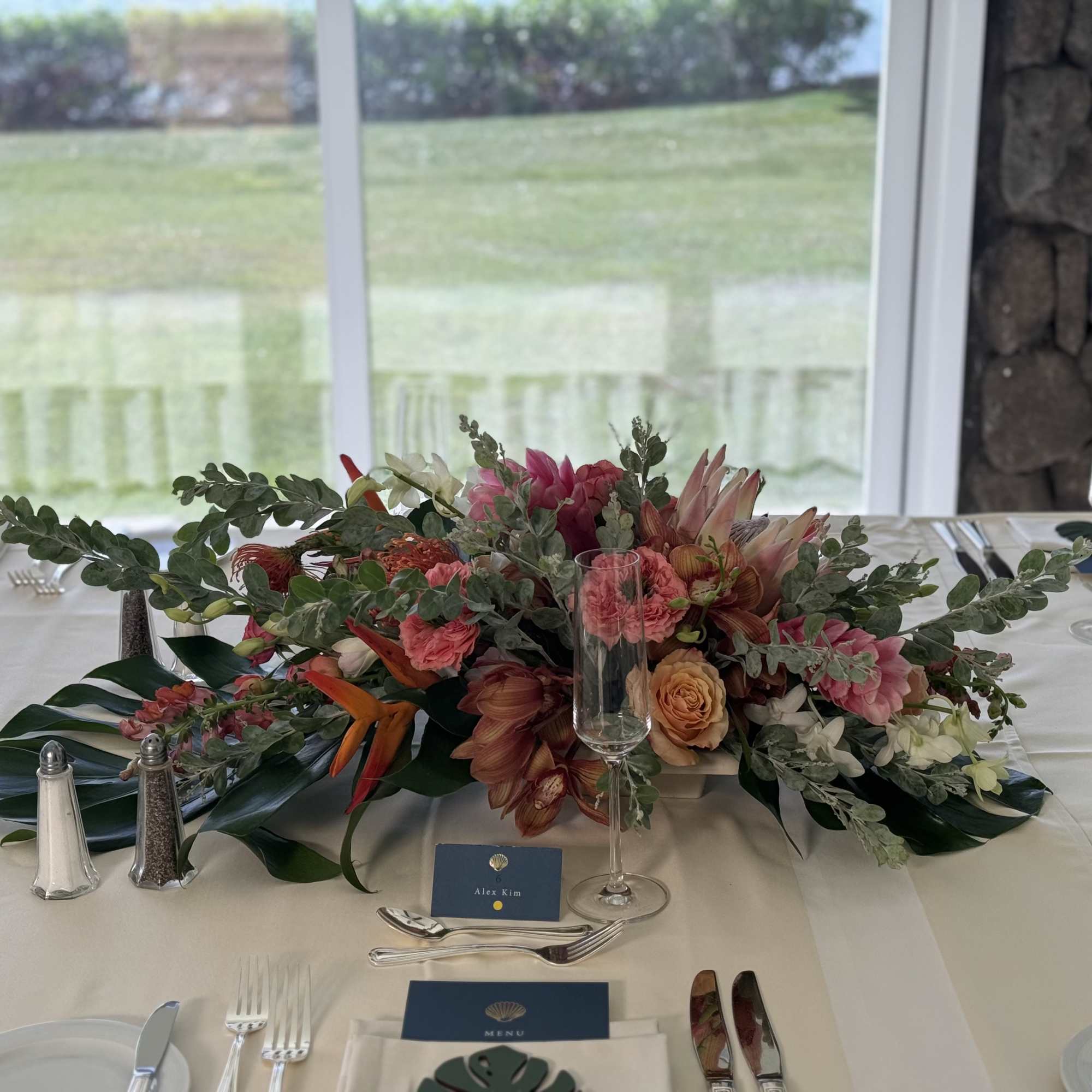 Embrace the spirit of Hawaii with this stunning pink tropical centerpiece. Expertly