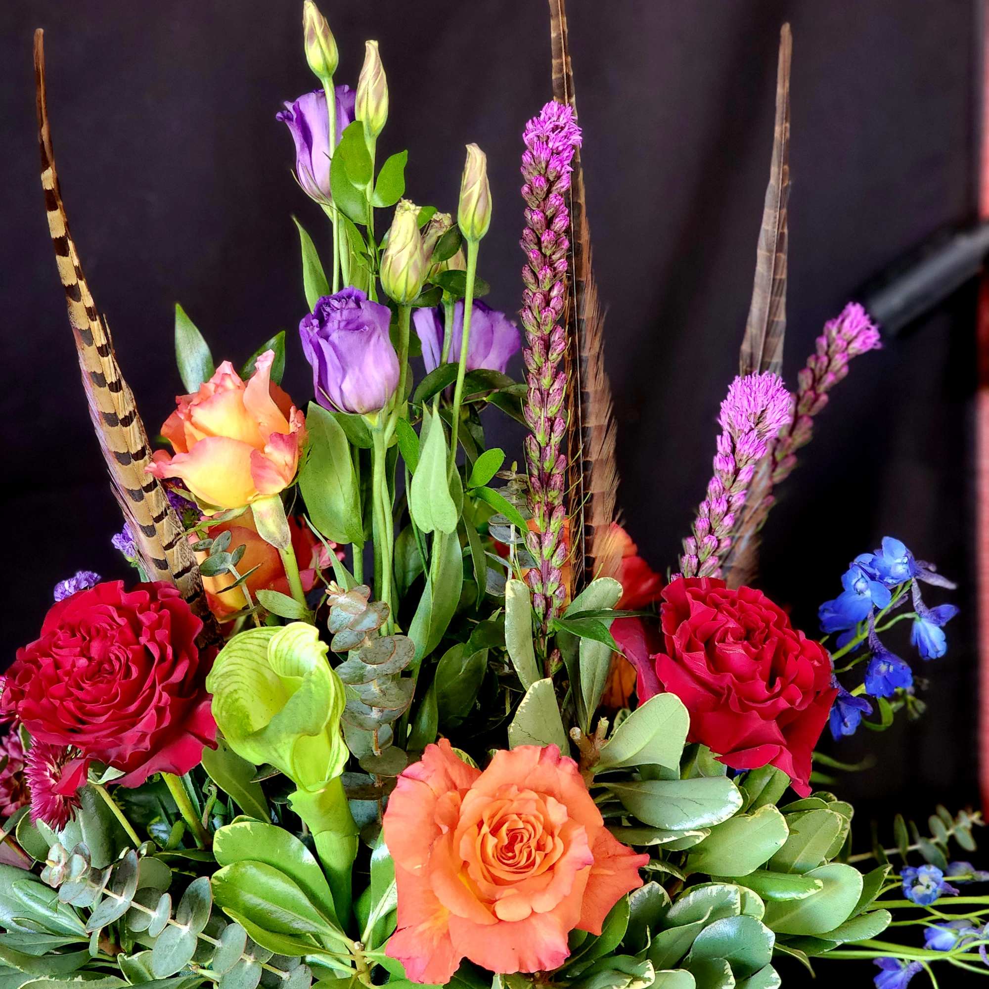 **One week notice required.**
Free Spirit roses and seasonal flowers with feathers to