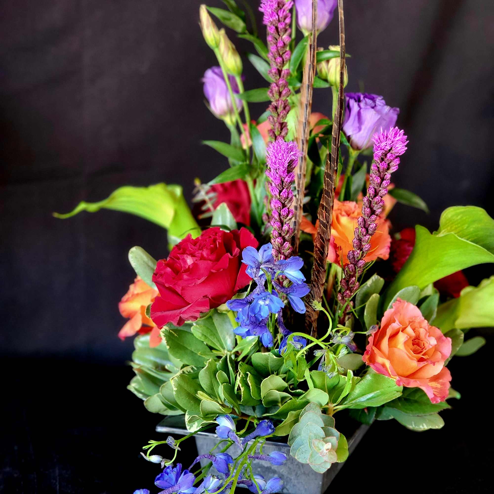 **One week notice required.**
Free Spirit roses and seasonal flowers with feathers to
