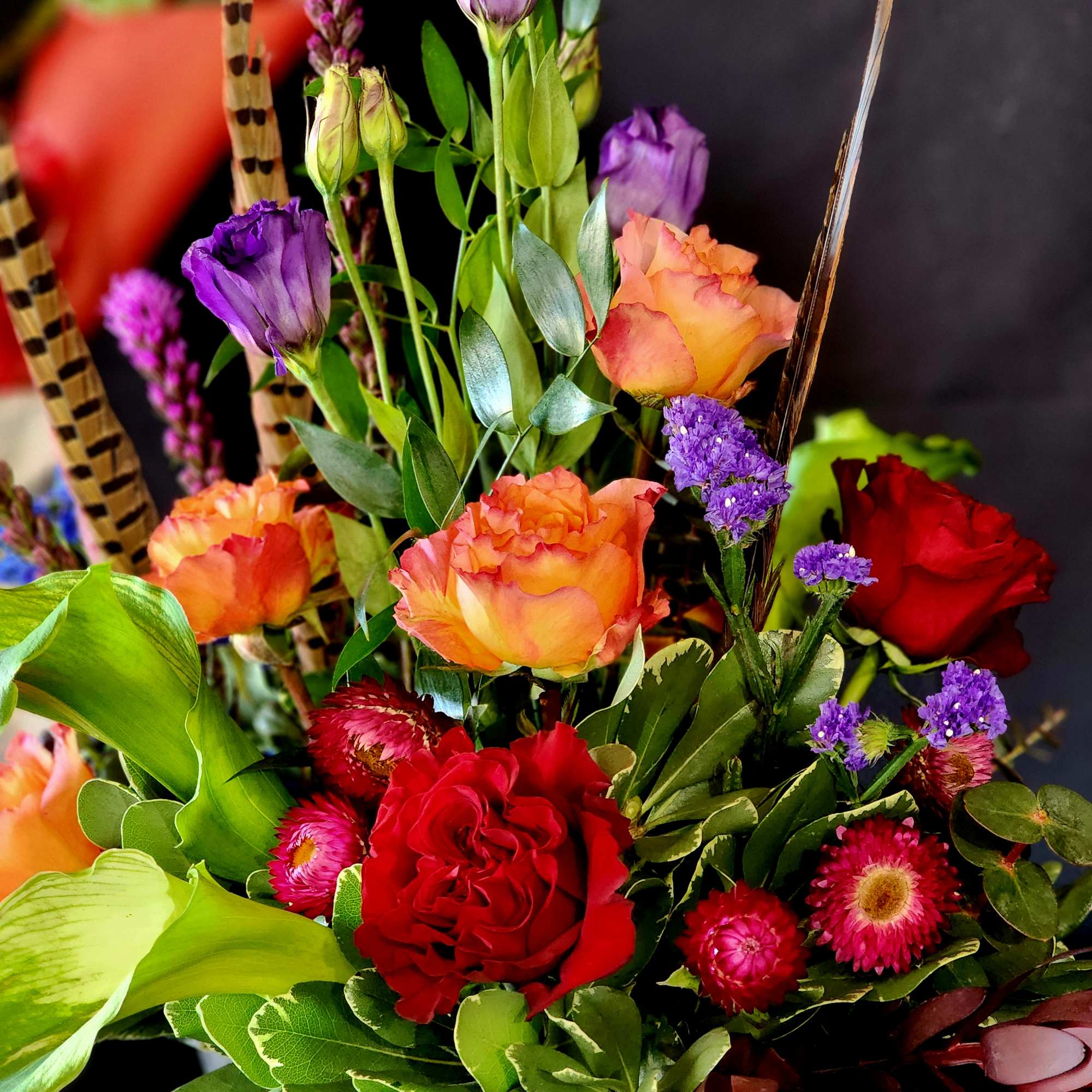**One week notice required.**
Free Spirit roses and seasonal flowers with feathers to