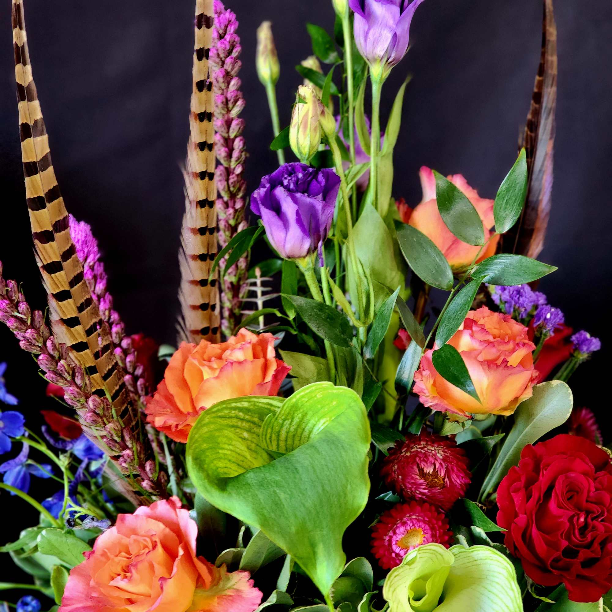 **One week notice required.**
Free Spirit roses and seasonal flowers with feathers to