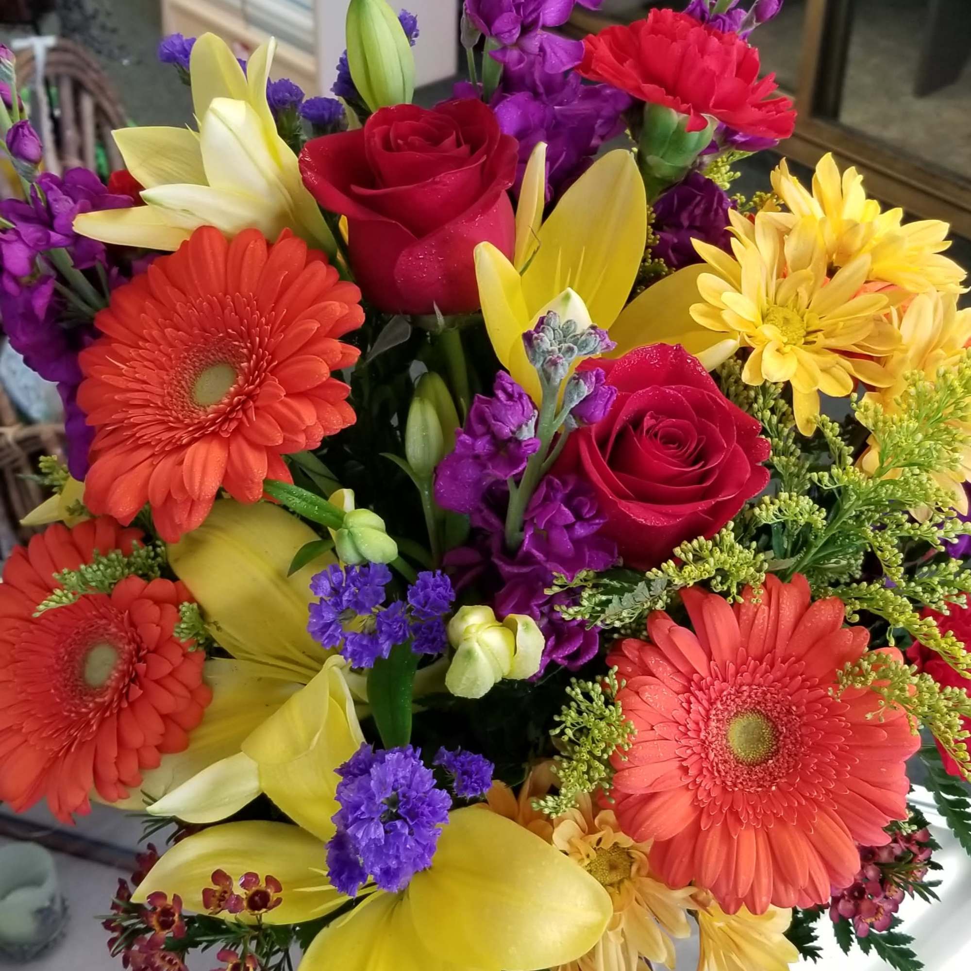 Lilies, roses, gerbera daisies, stock, statice, solidago, daisies, and wax flower. Lilies, roses, gerbera daisies, stock, statice, solidago, daisies, and wax flower.