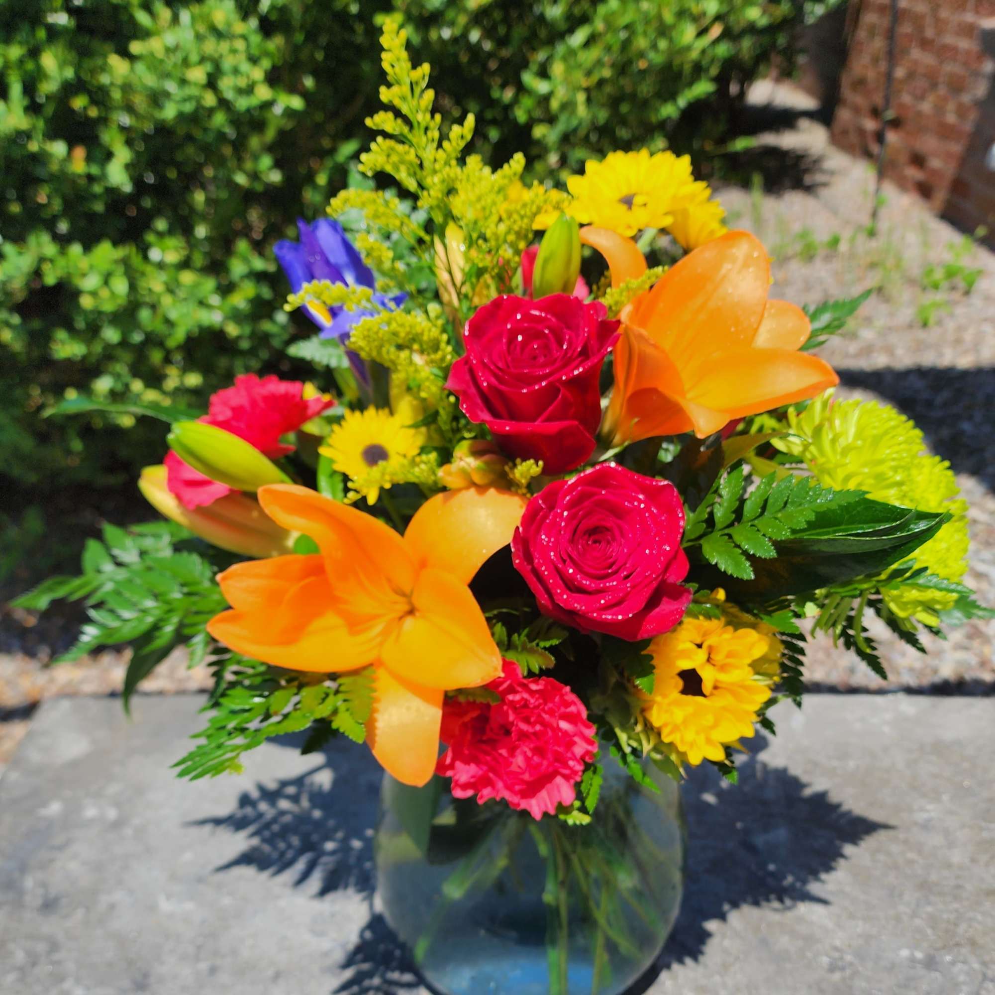 Designed in a beautiful large aqua vase.  This arrangement includes lilies