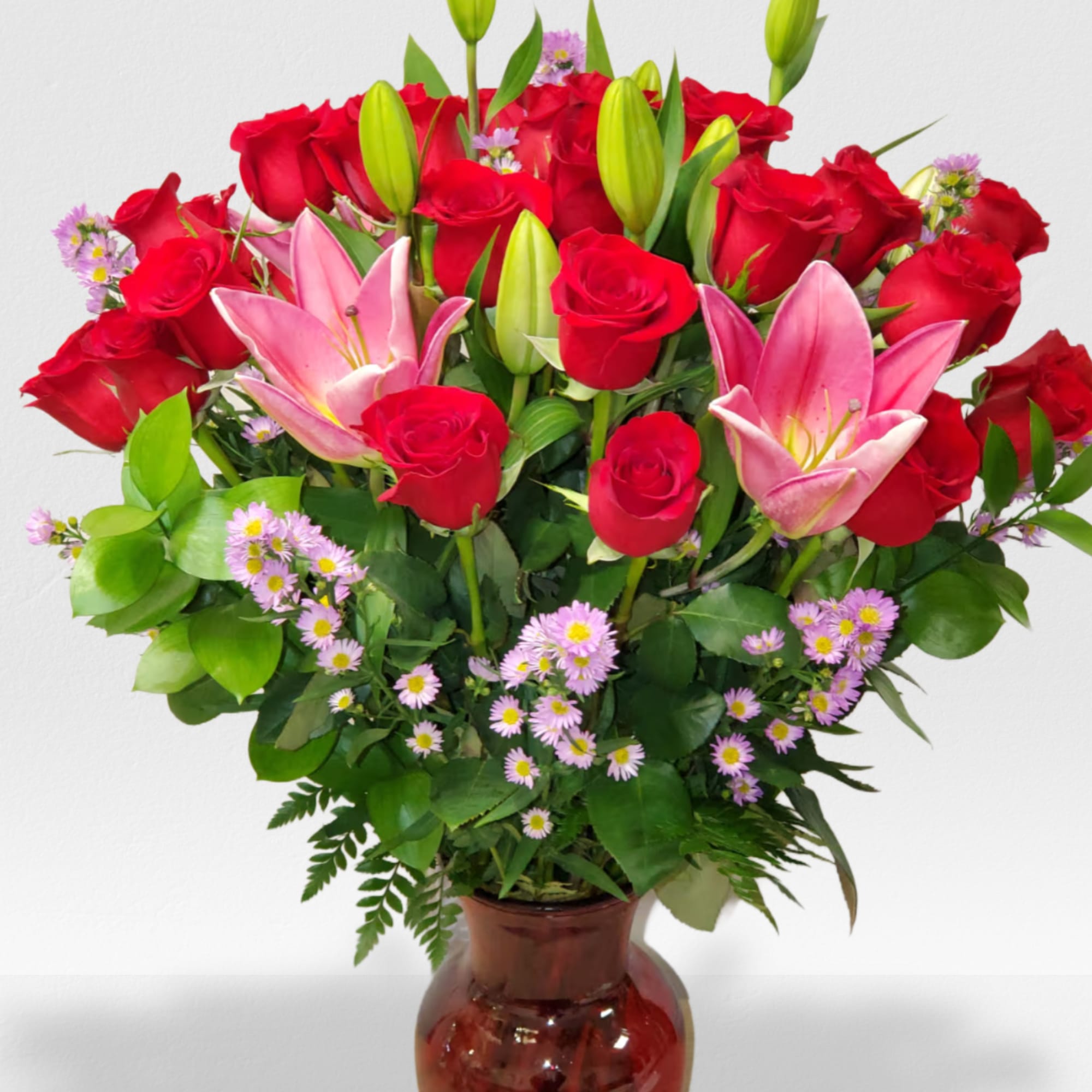 A beautiful vase arrangement in a red or clear vase 24 Rose&#039;s