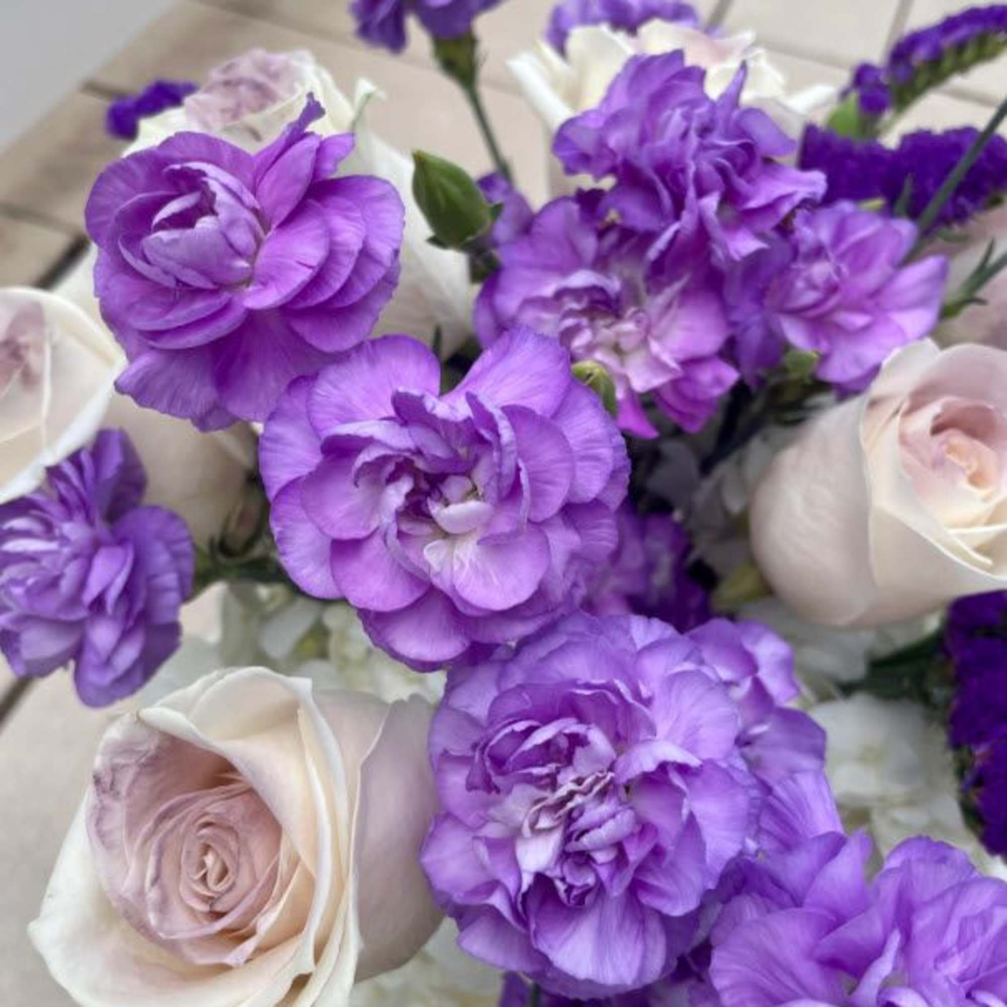 This elegant bouquet features a soft blend of white hydrangeas, creamy roses