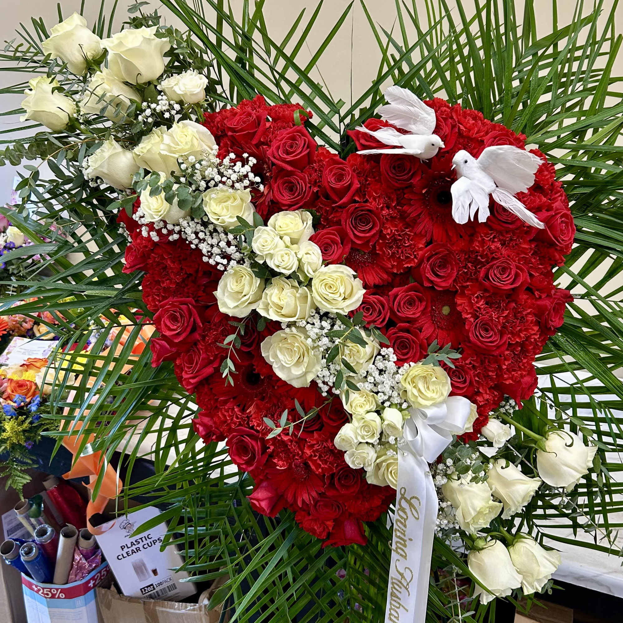 Solid mixed red flowers with a white rose break