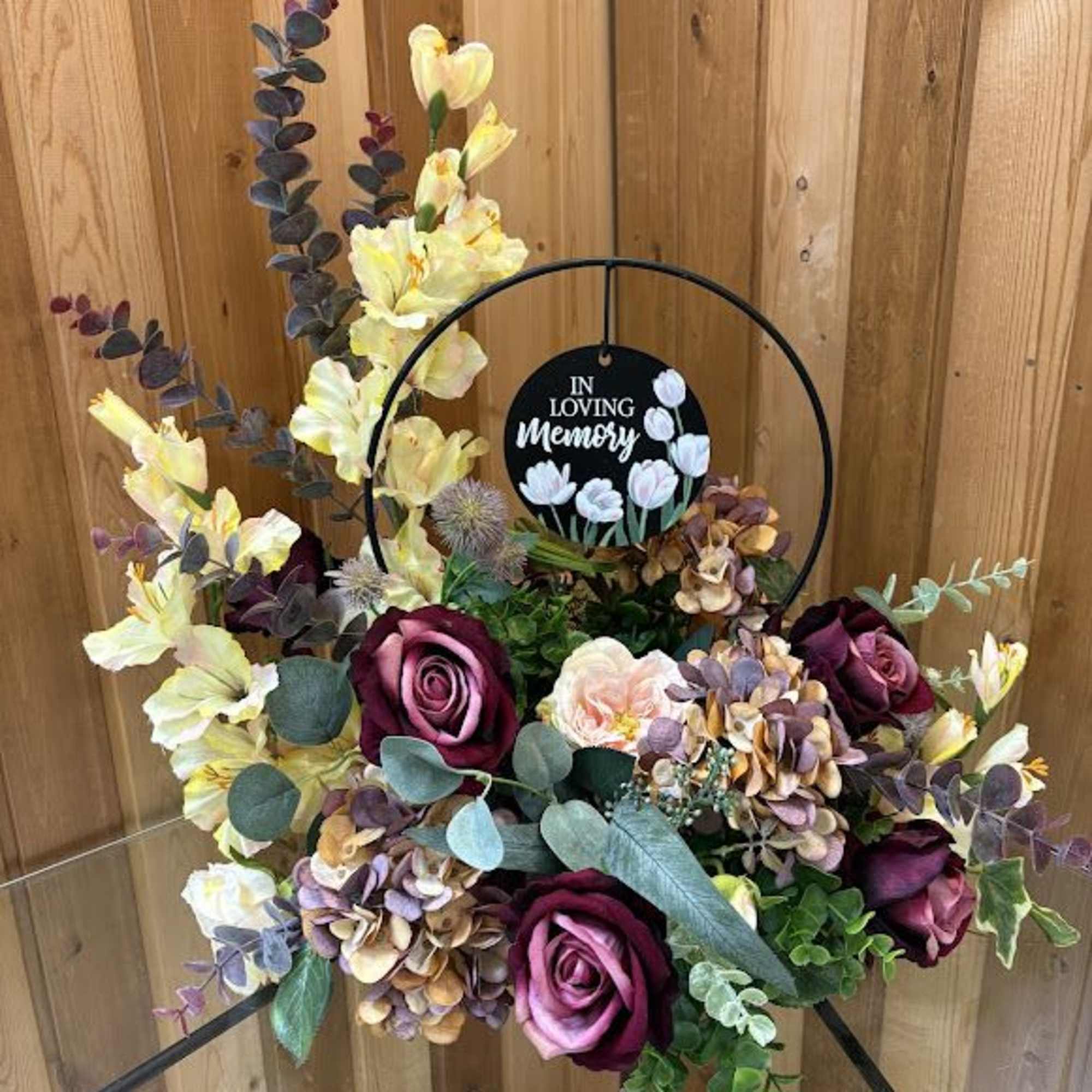 This silk arrangement has a keepsake included with a decorative place that This silk arrangement has a keepsake included with a decorative place that