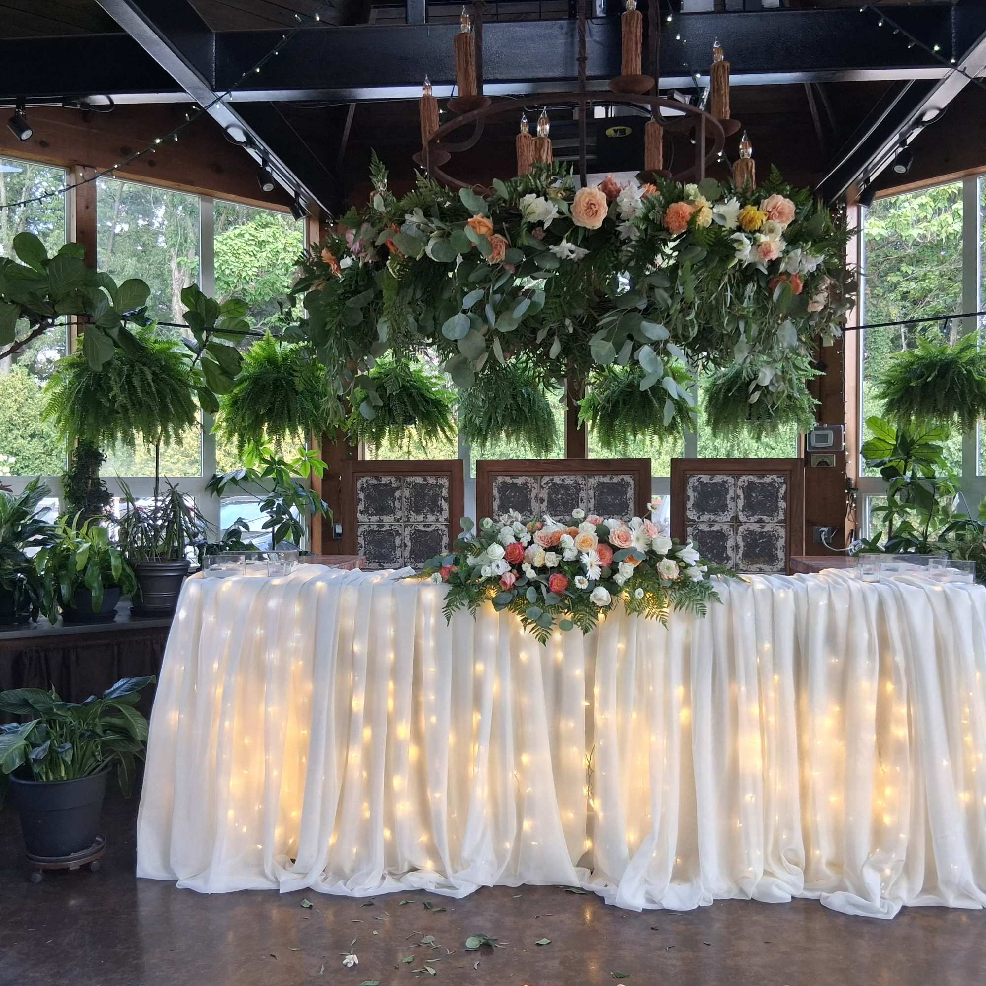 Beautiful bohemian style altar centerpiece with roses, carnations, dahlias, daisies and other