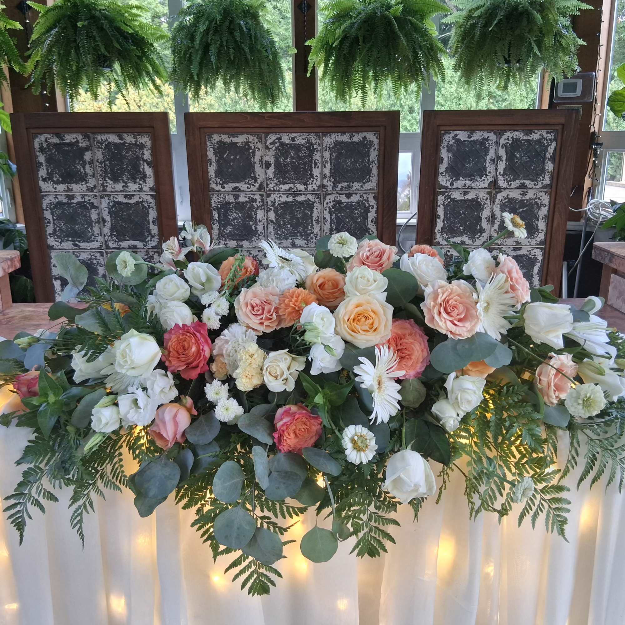 Beautiful bohemian style altar centerpiece with roses, carnations, dahlias, daisies and other