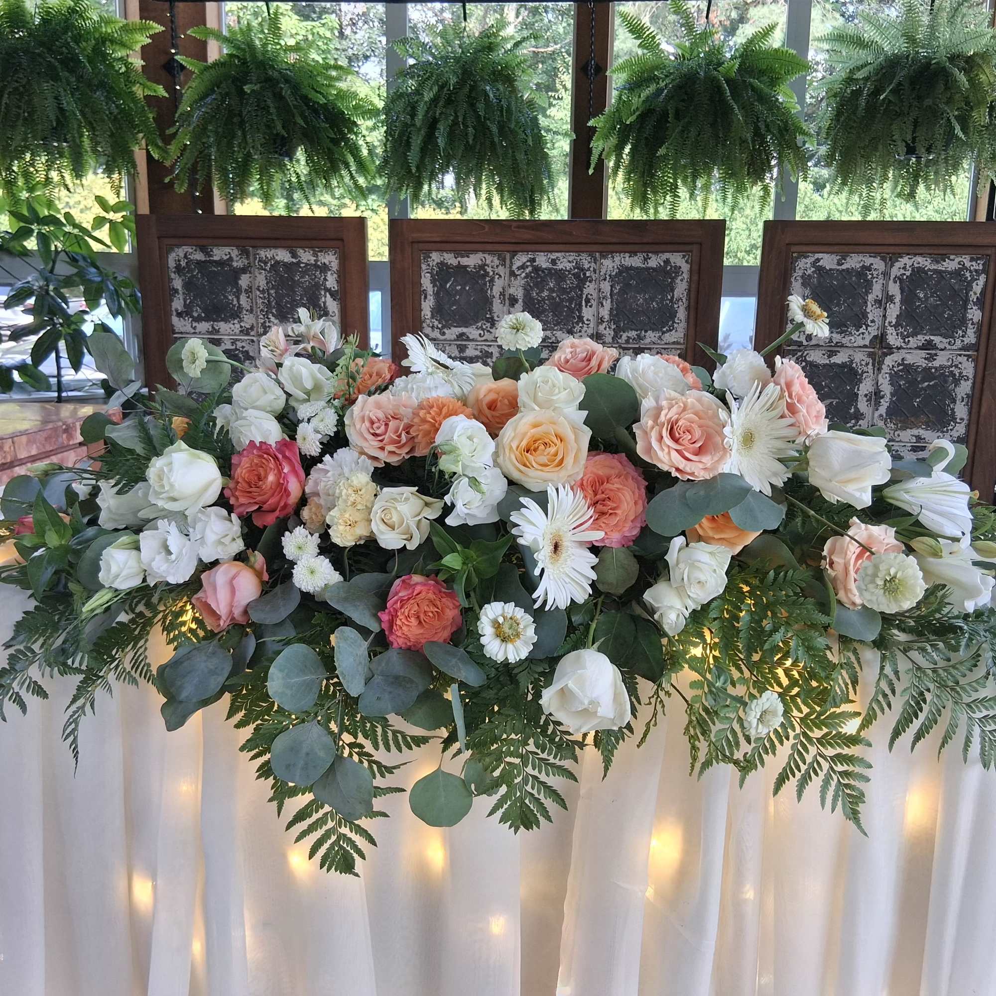 Beautiful bohemian style altar centerpiece with roses, carnations, dahlias, daisies and other