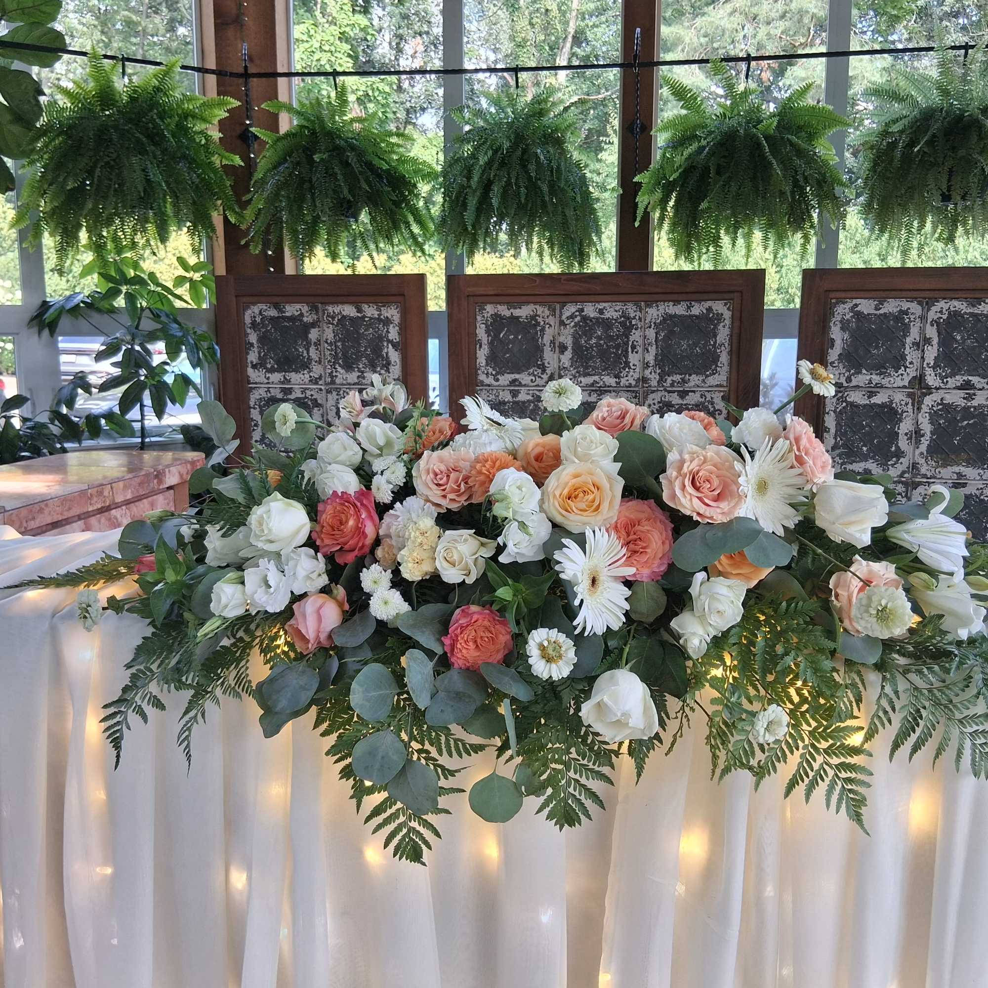 Beautiful bohemian style altar centerpiece with roses, carnations, dahlias, daisies and other