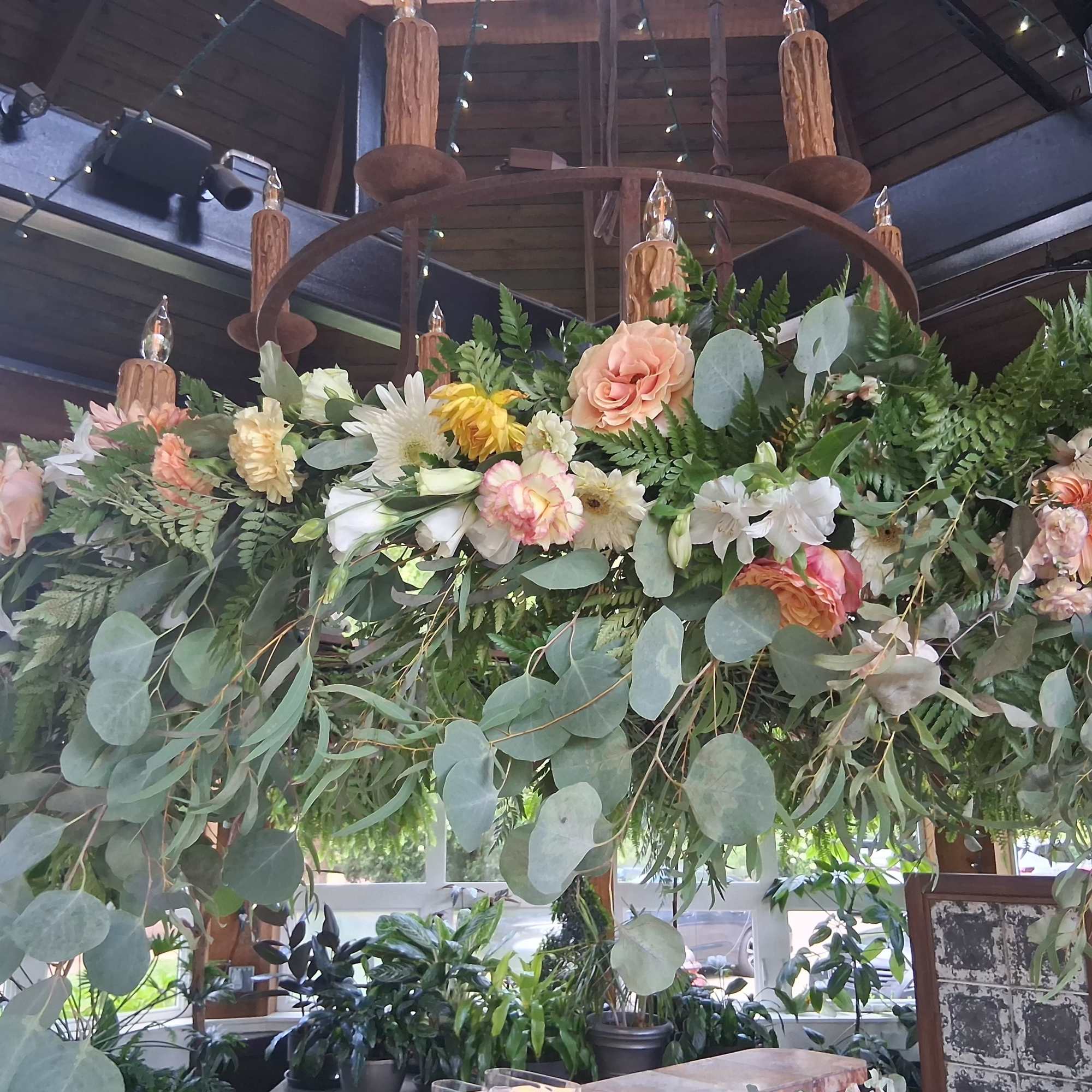 Floral garland around chandelier 