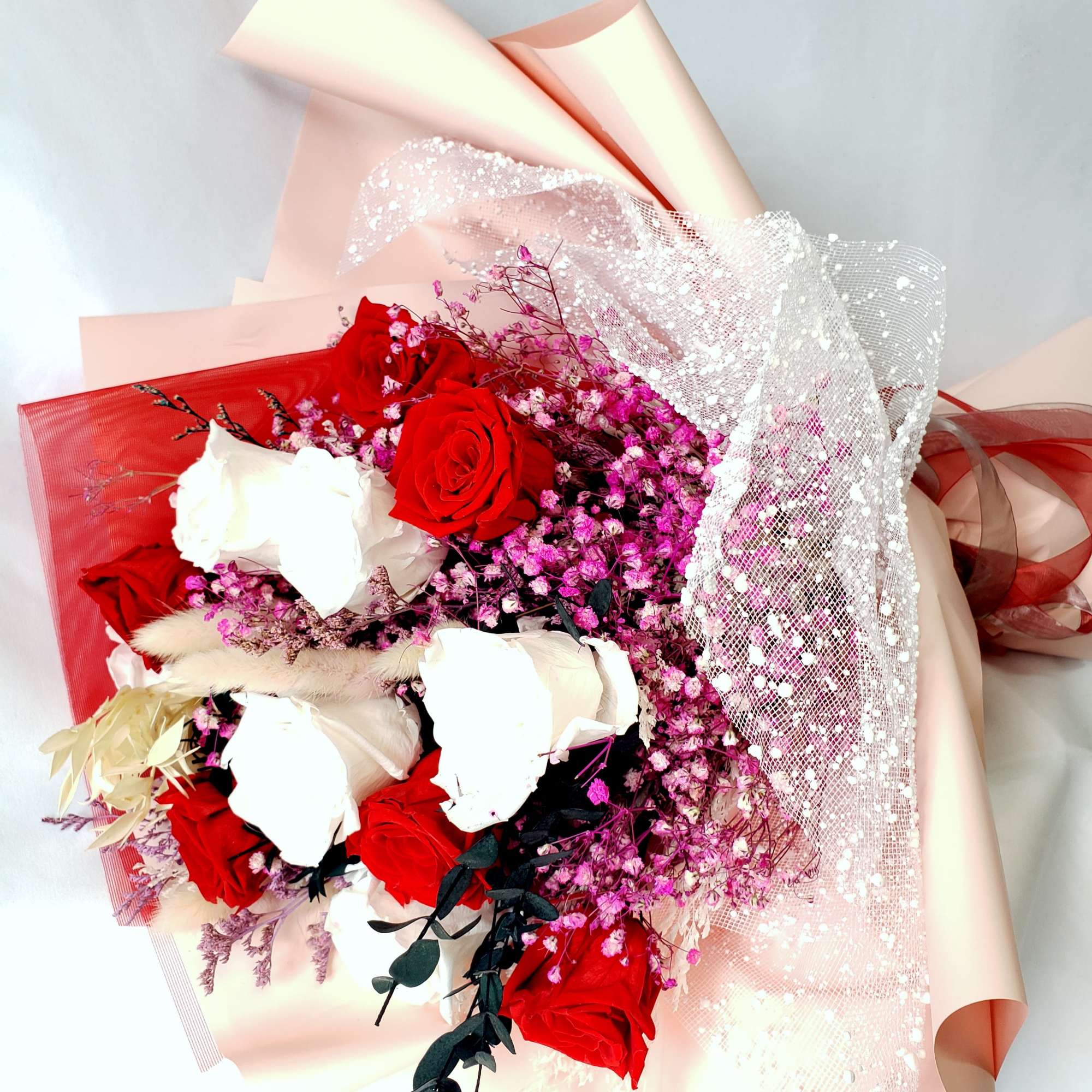 6 red, 6 white preserved roses in bouquet mixed with fillers 6 red, 6 white preserved roses in bouquet mixed with fillers