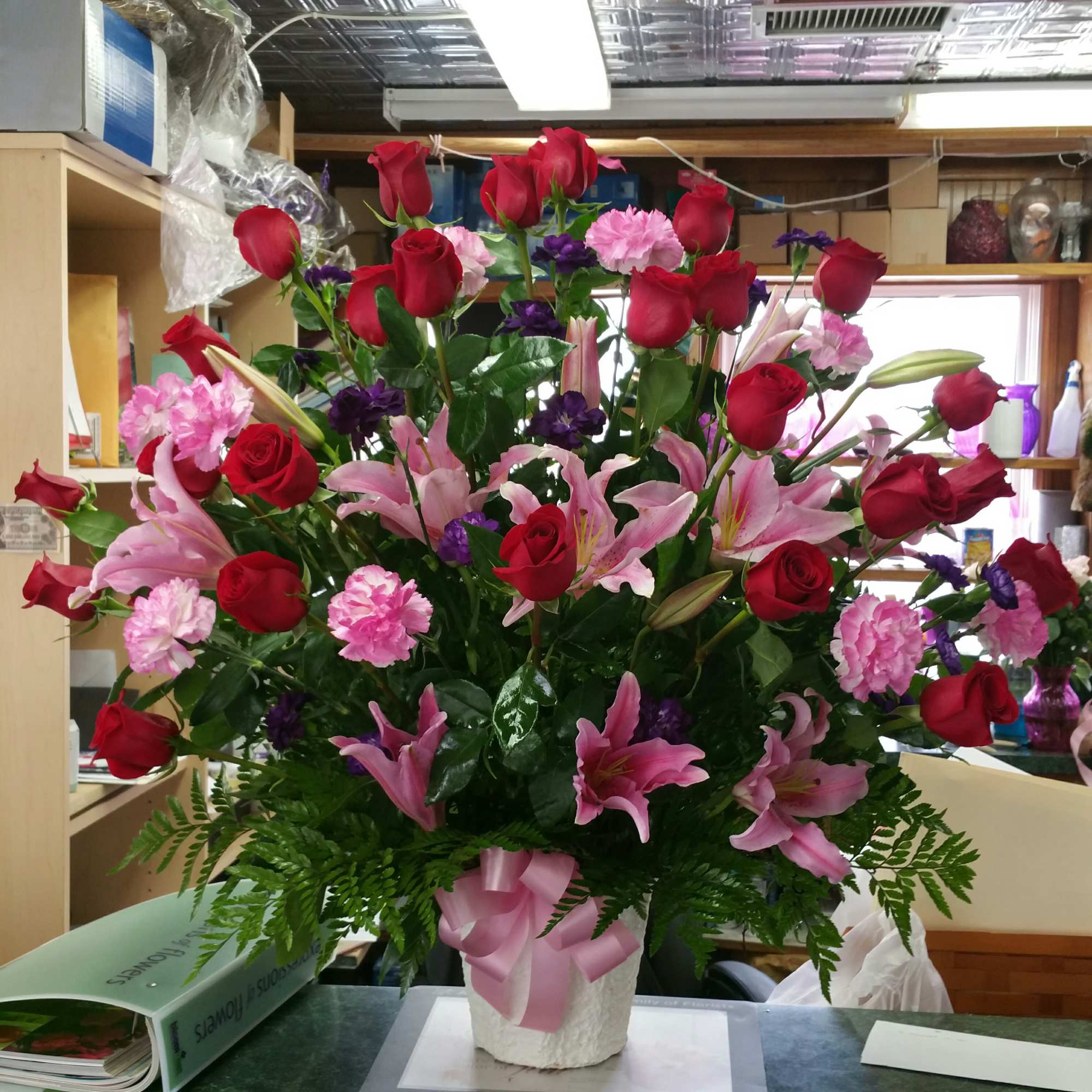 on a  vase with roses and star gazers