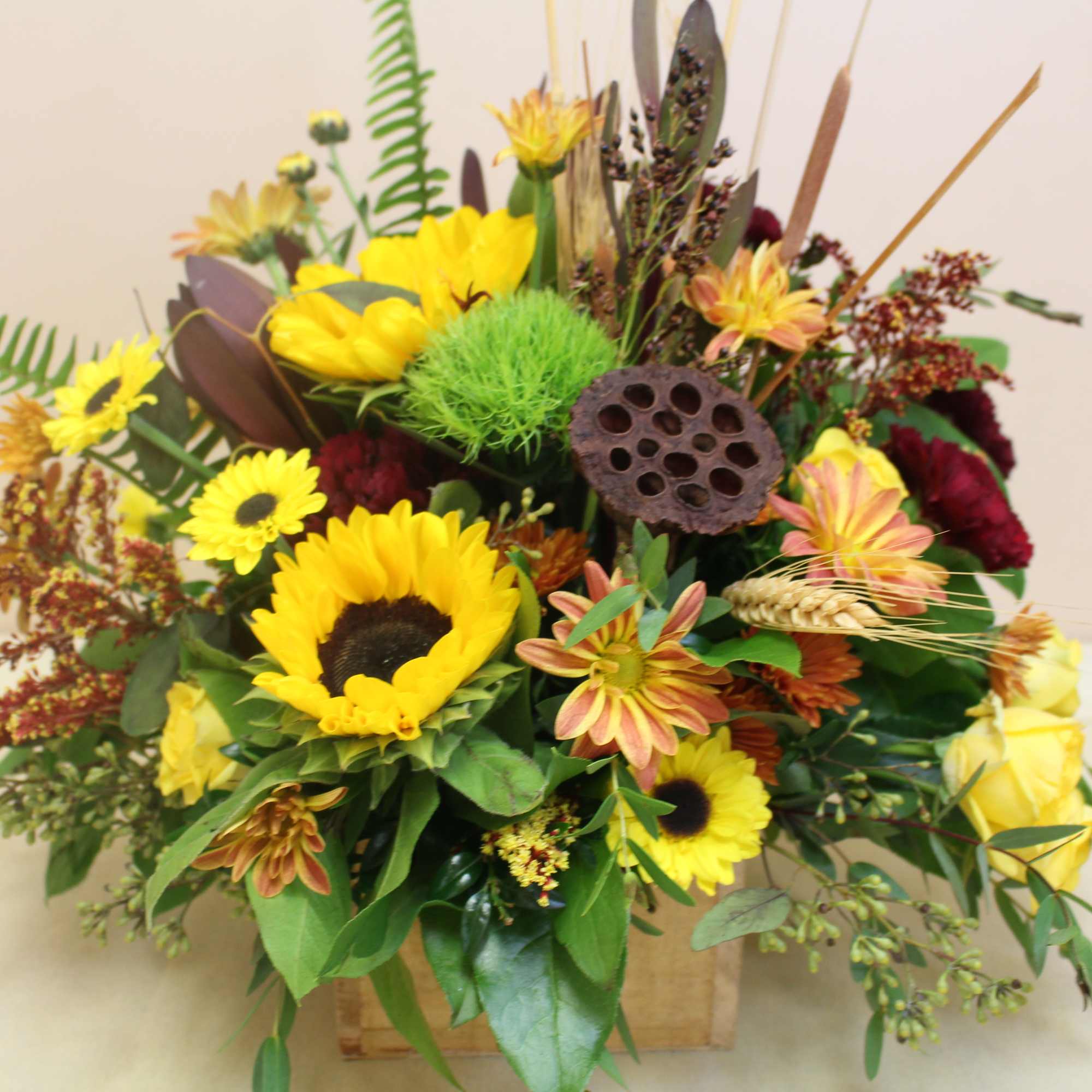 in a wooden box filled with fall array of flowers in a wooden box filled with fall array of flowers
