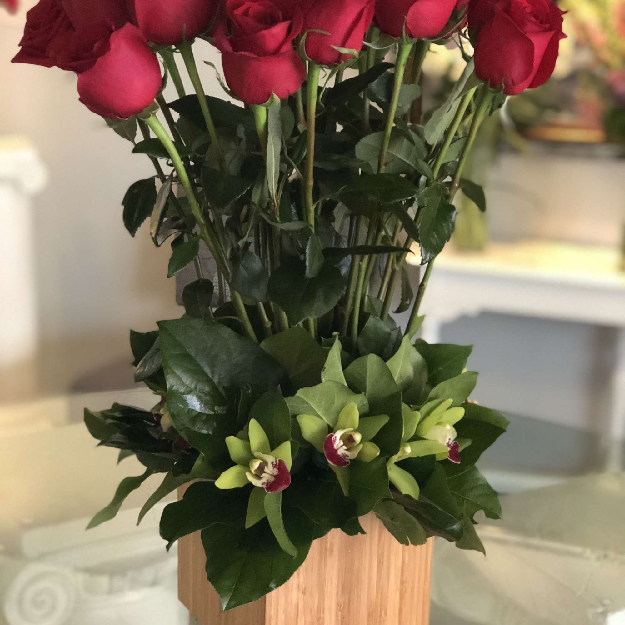 A unique presentation of 24 long-stemmed, ruby-red Roses, in a beautiful base