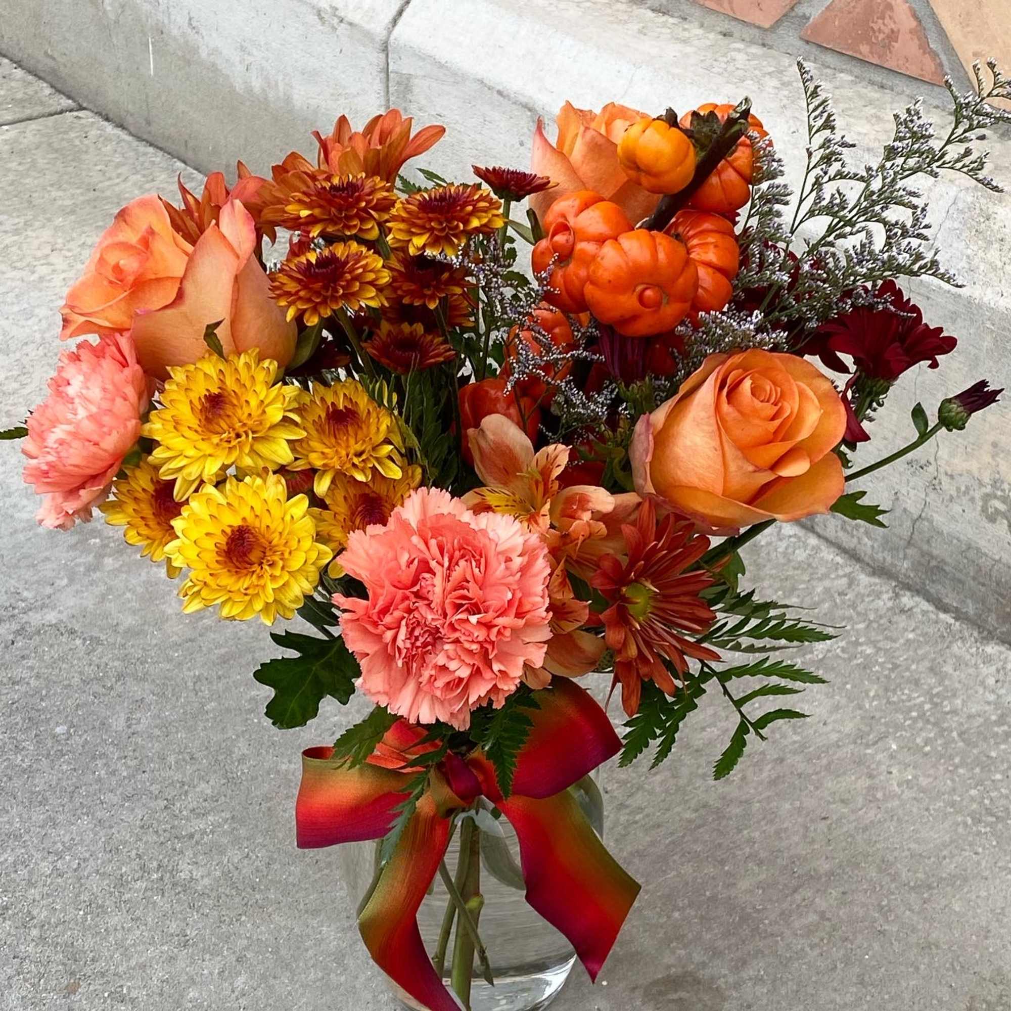 This is a mixed of chrysanthemum, daisy, asltromerias, roses, carnation, and mini