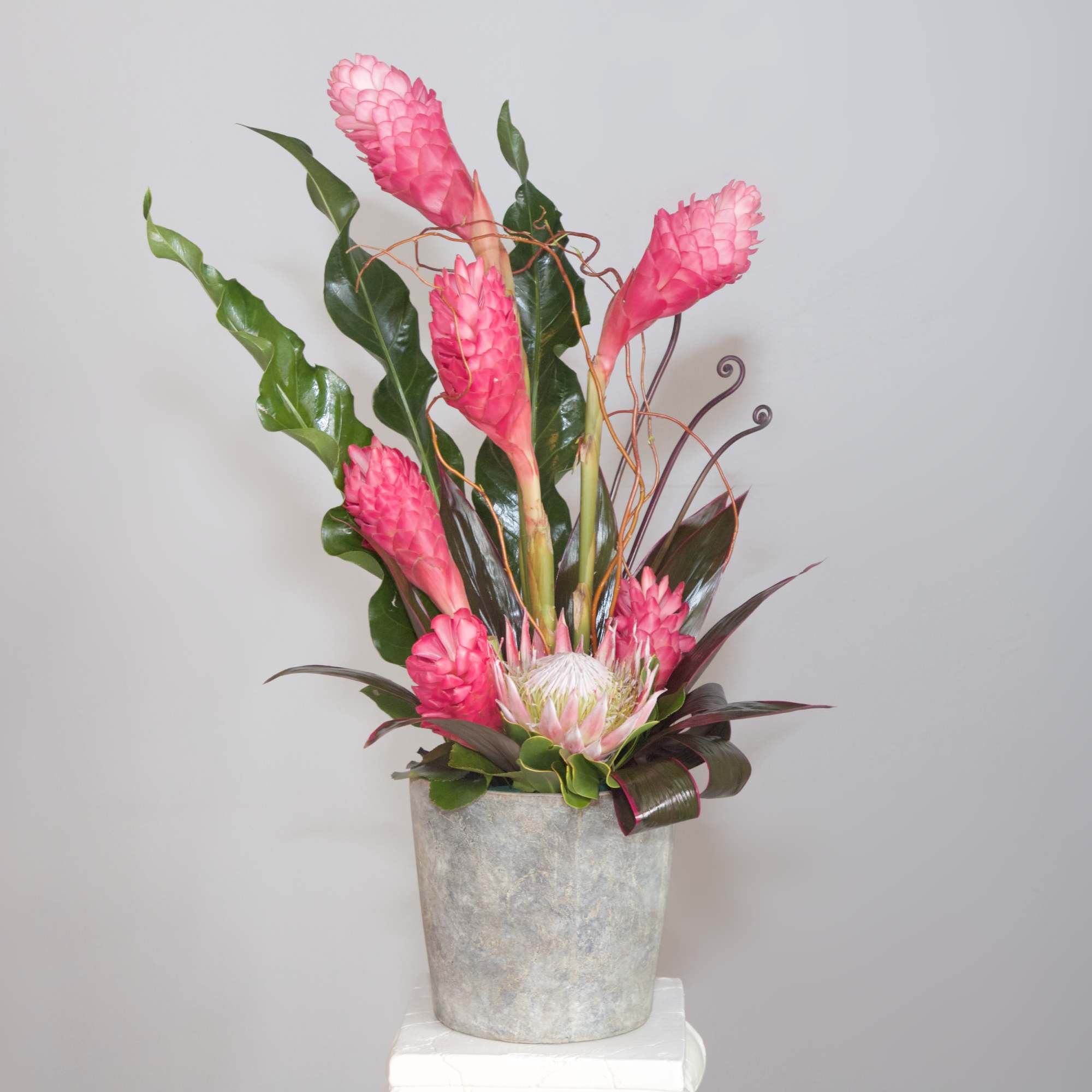 Show your love and devotion with this contemporary tropical arrangement of pink