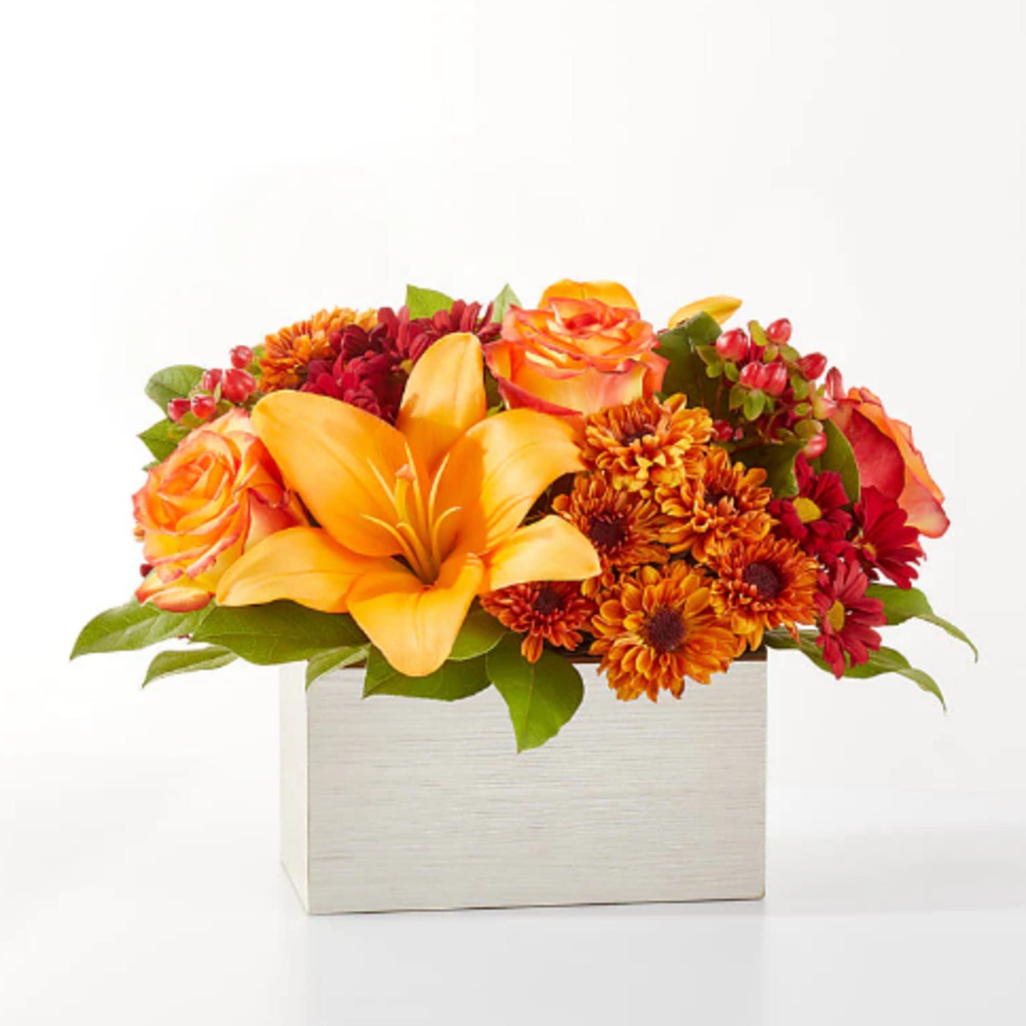 Step into autumn with fiery red and orange petals, expertly arranged to