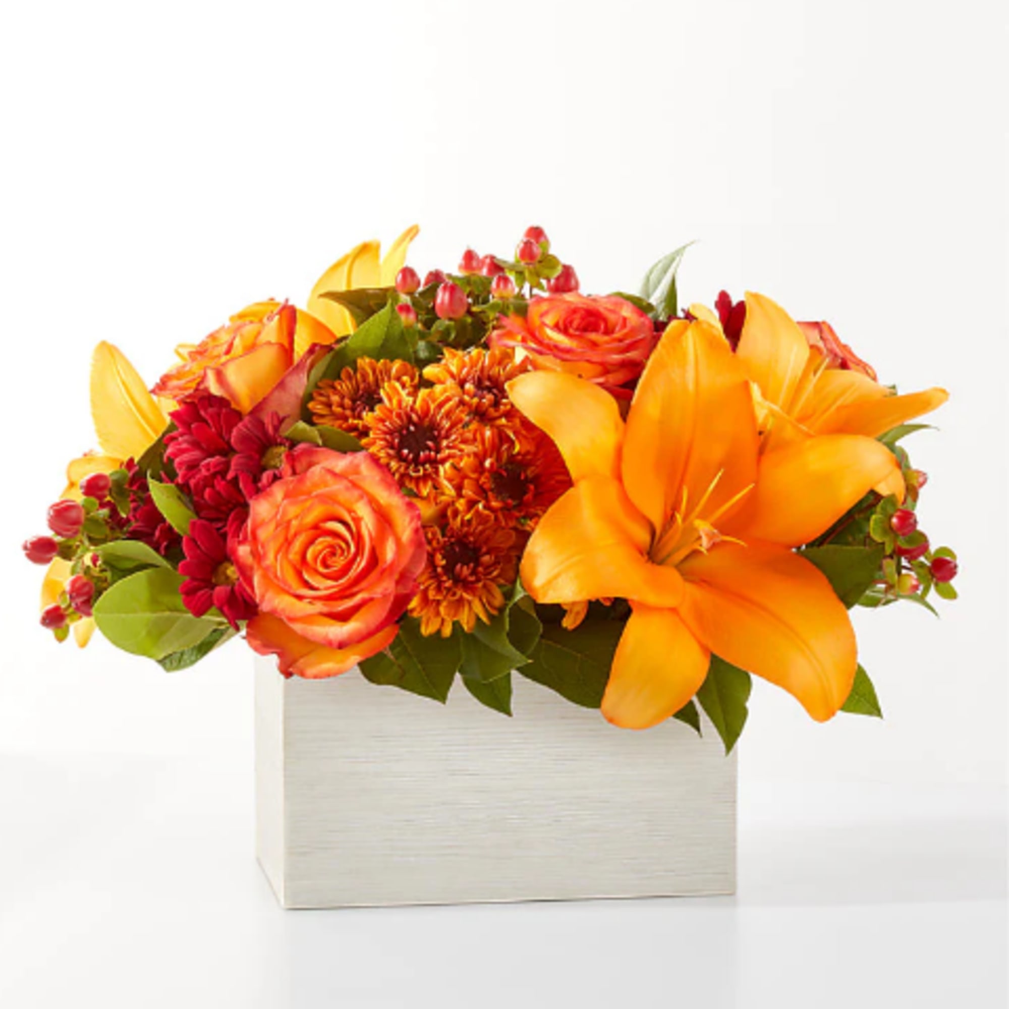 Step into autumn with fiery red and orange petals, expertly arranged to