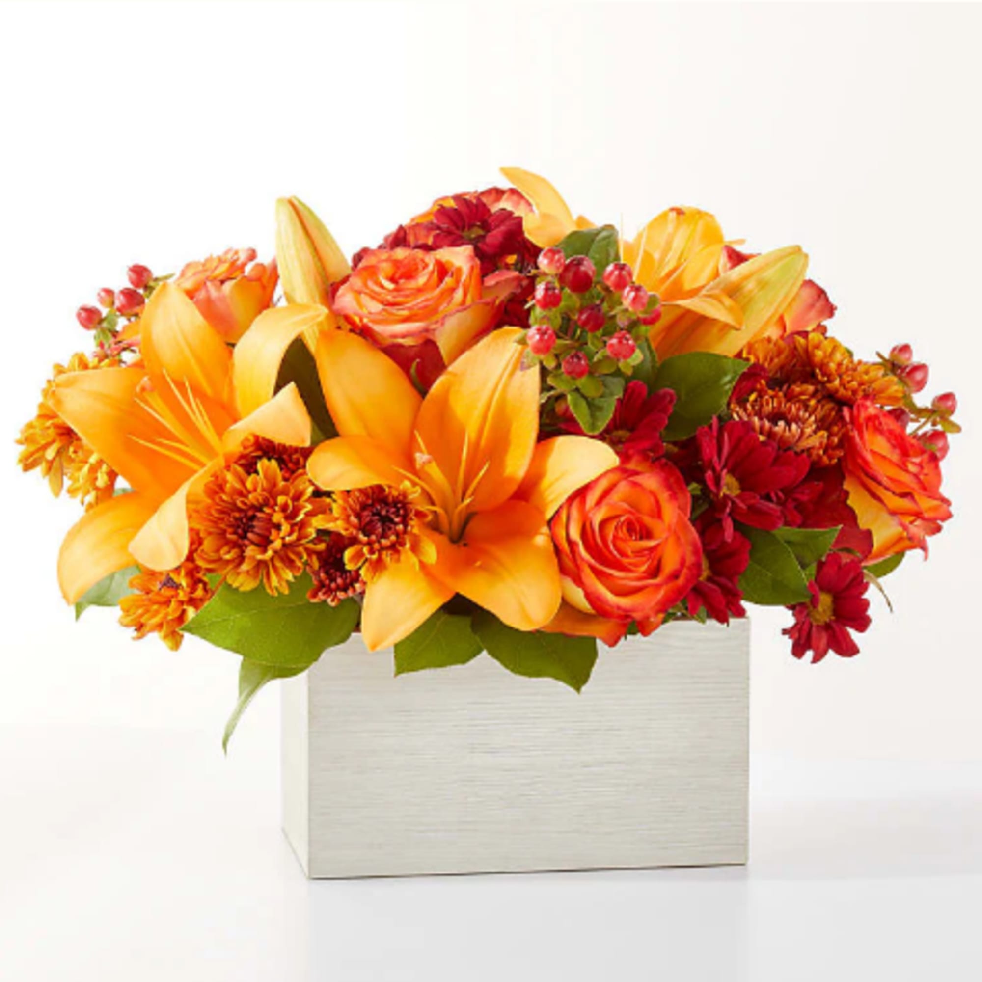 Step into autumn with fiery red and orange petals, expertly arranged to