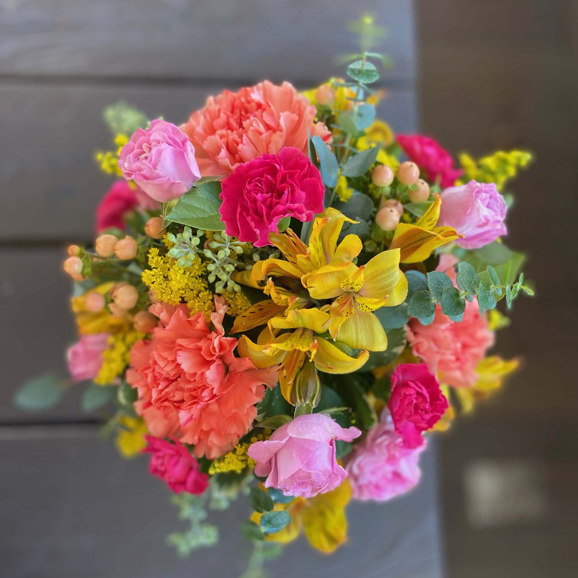 Celebrate fall with an arrangement that is designed in an orange ceramic