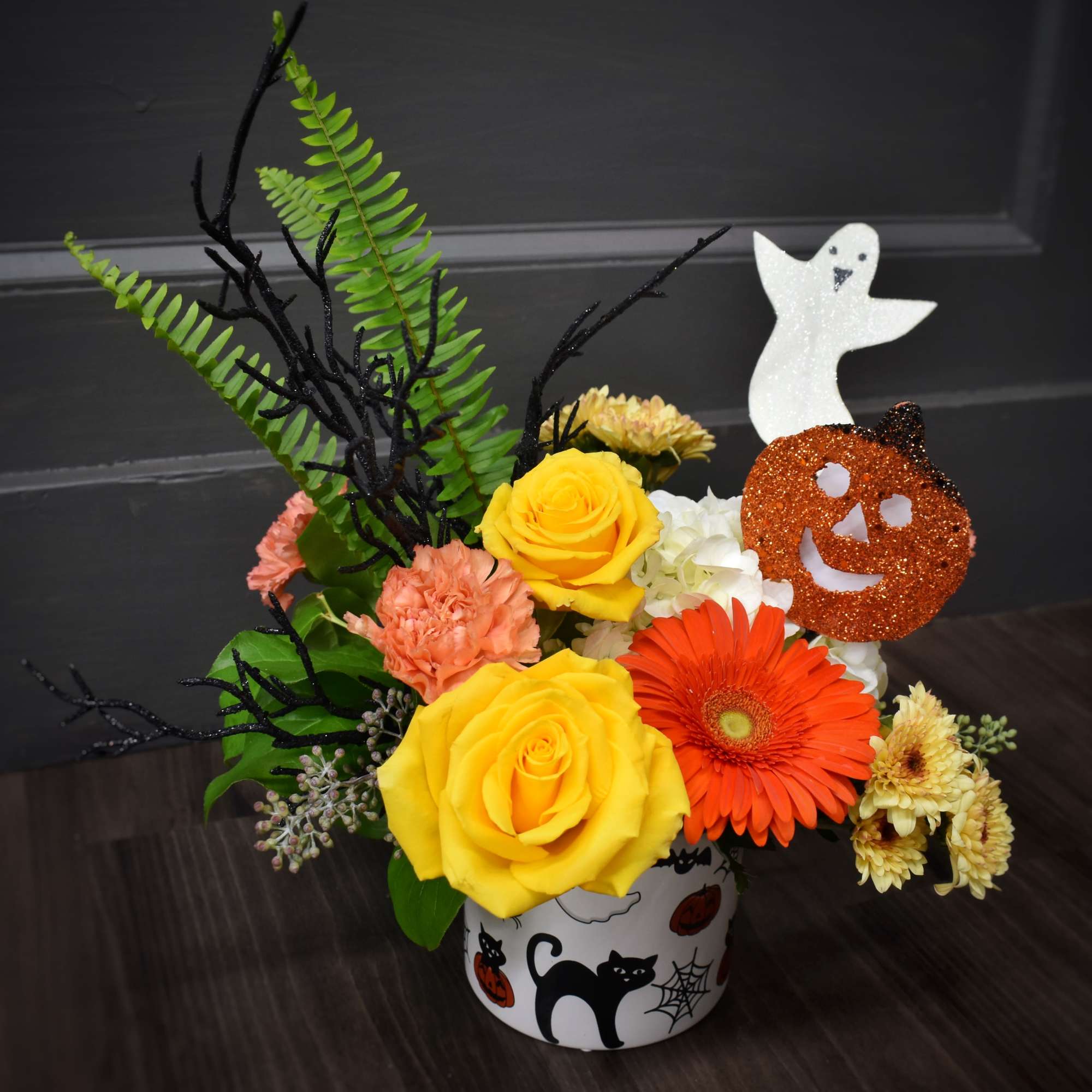 Boo! Don't be scared, it's just flowers. A ghost floating above a Boo! Don't be scared, it's just flowers. A ghost floating above a