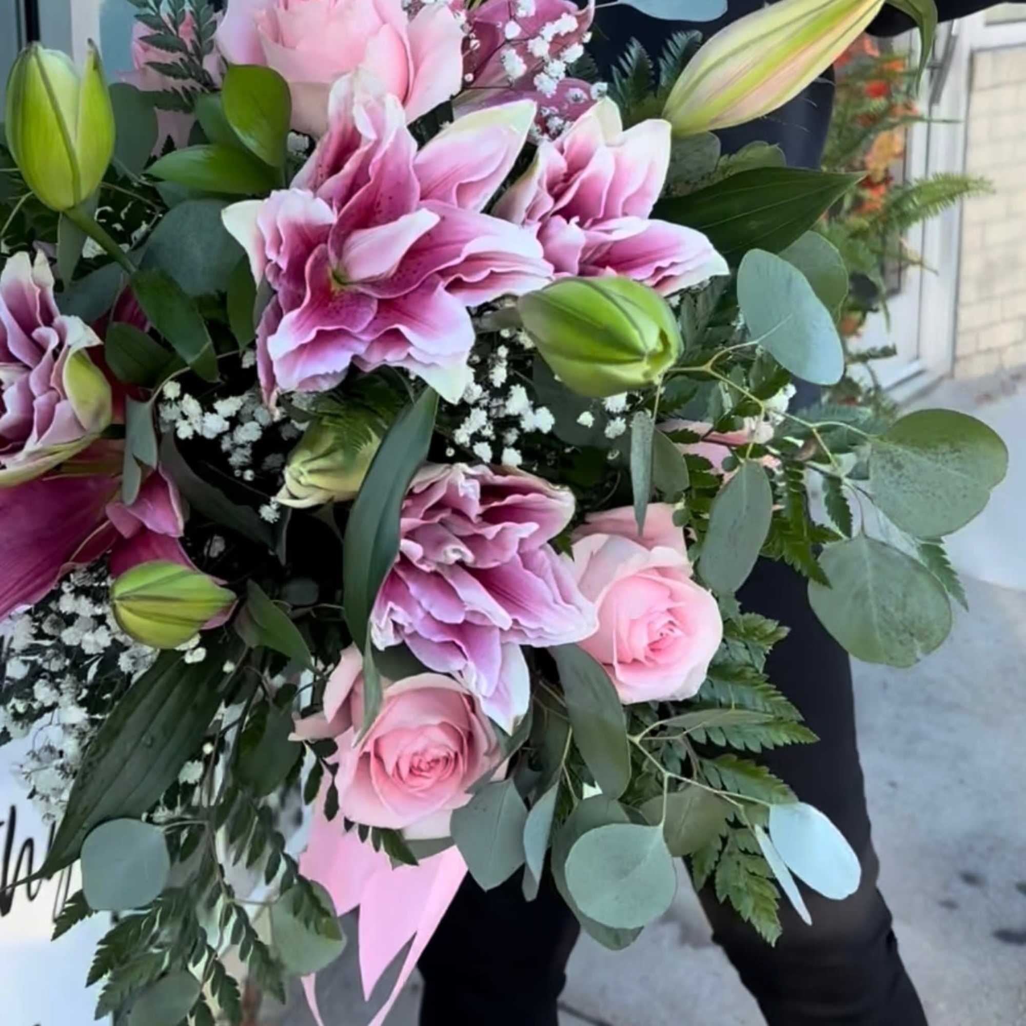 Roses and Lilies and babies breath in a hand tied bouquet...a perfect