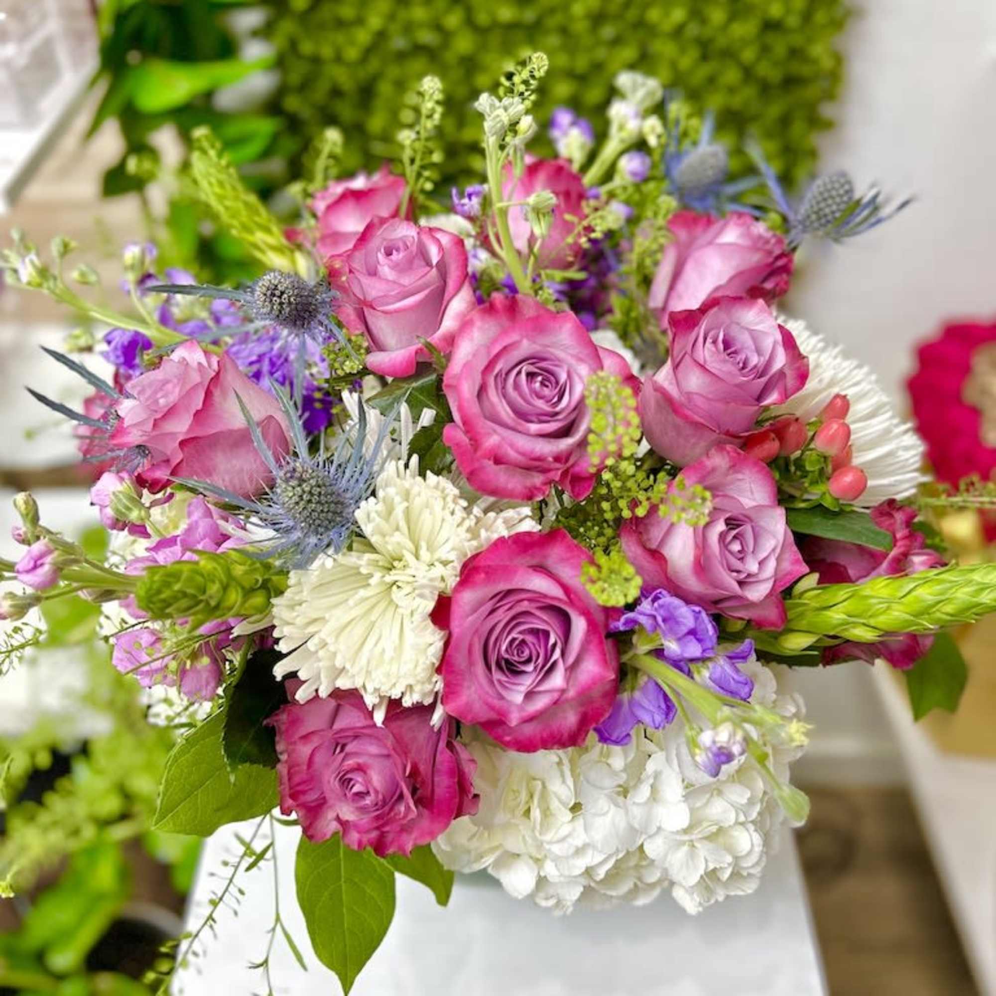 Hydrangeas and Roses Arrangement: FishBowl vase arrangement accented with hydrangeas, greens, and