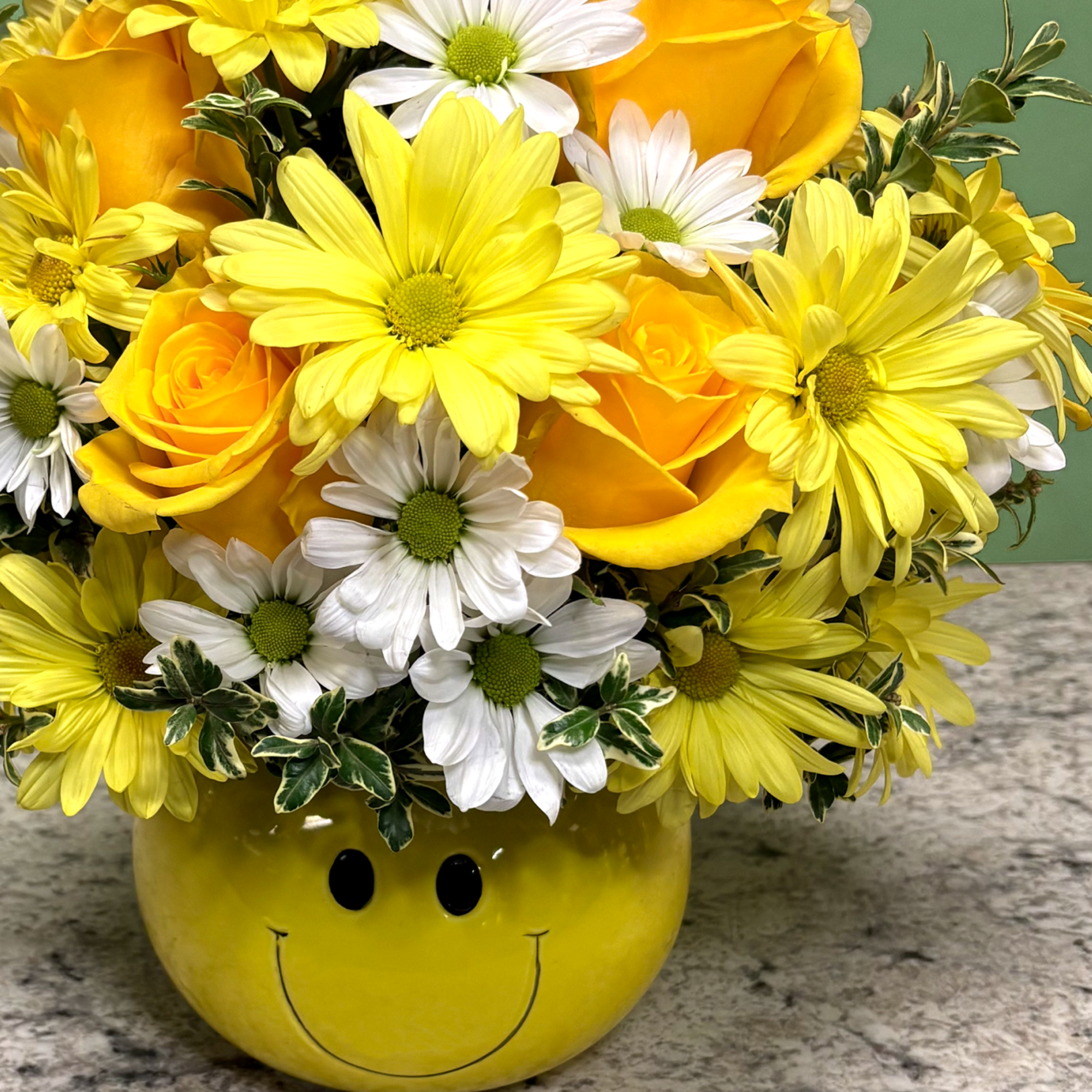 A cheerful arrangement designed to brighten any day, featuring vibrant yellow roses