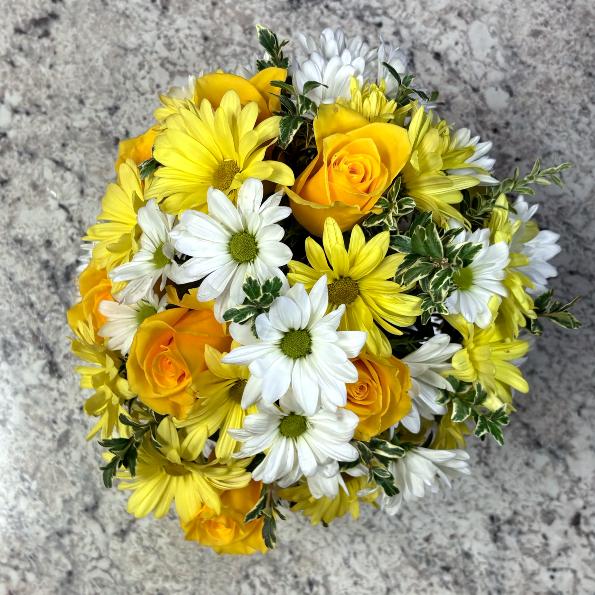 A cheerful arrangement designed to brighten any day, featuring vibrant yellow roses