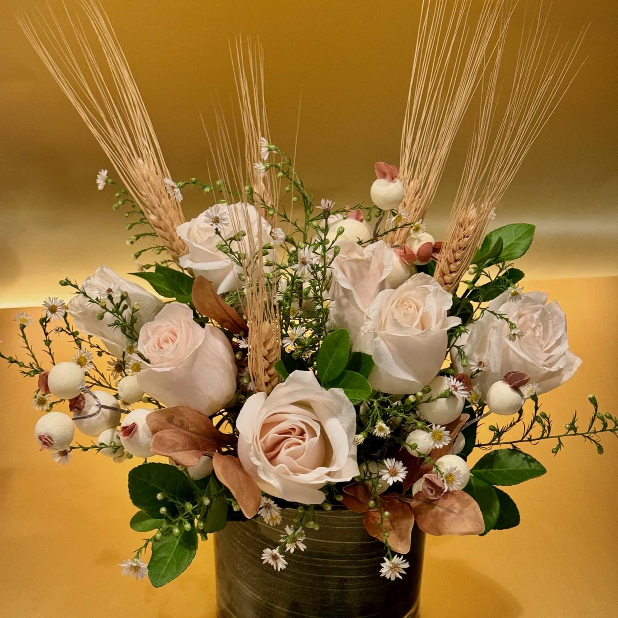 This elegant and timeless arrangement features creamy white roses as the centerpiece