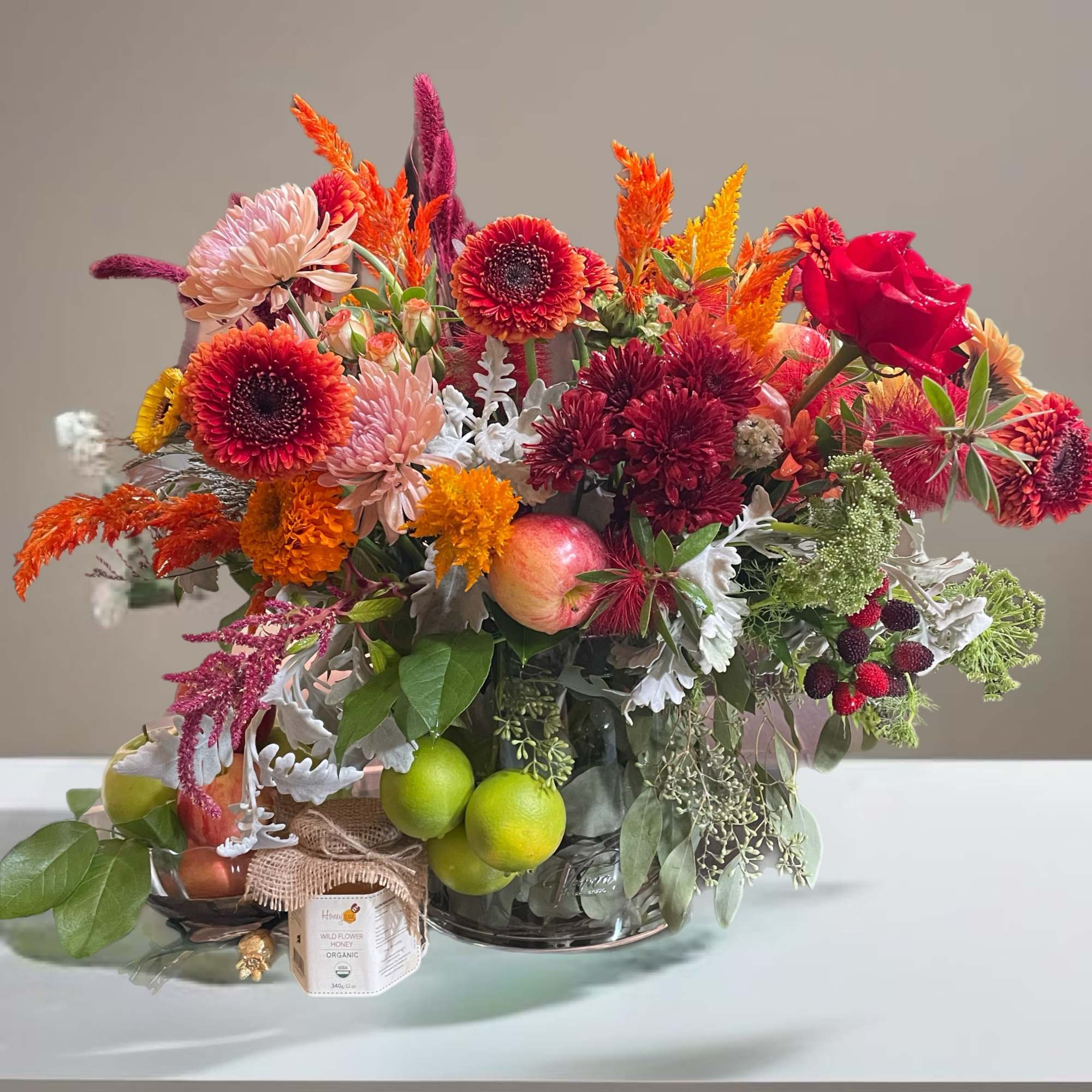 This arrangement in an elegant vase, with the orchids artfully displayed alongside
