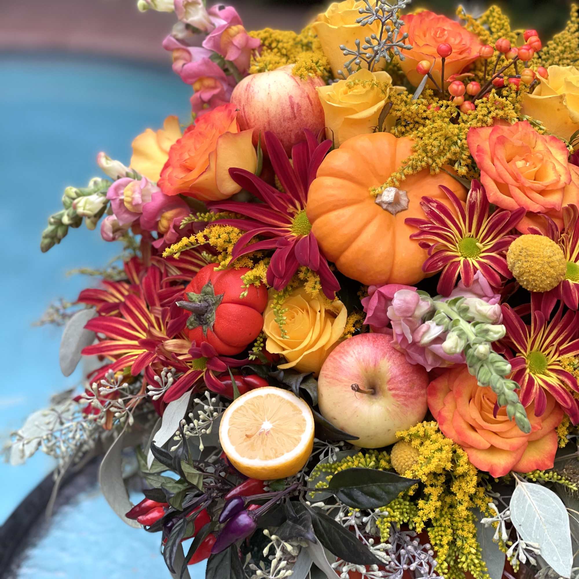 A pumpkin floral design is a charming and creative arrangement that combines