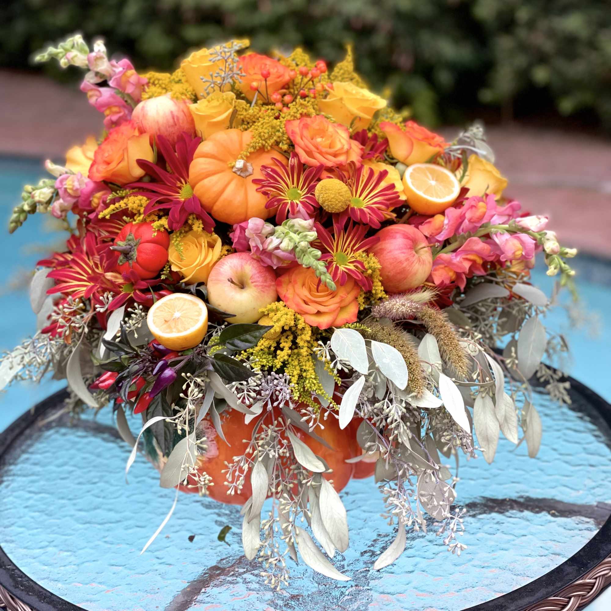 A pumpkin floral design is a charming and creative arrangement that combines