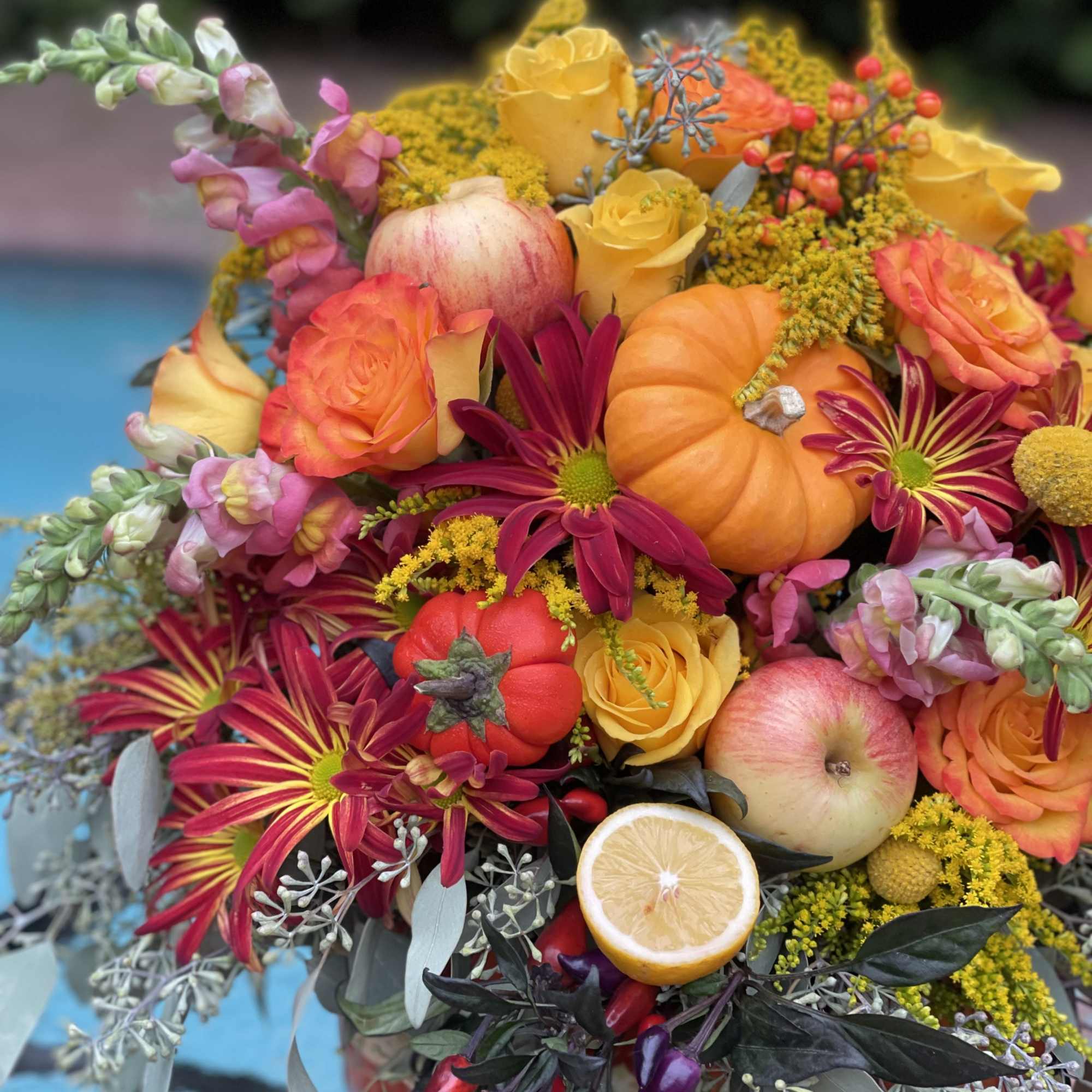 A pumpkin floral design is a charming and creative arrangement that combines