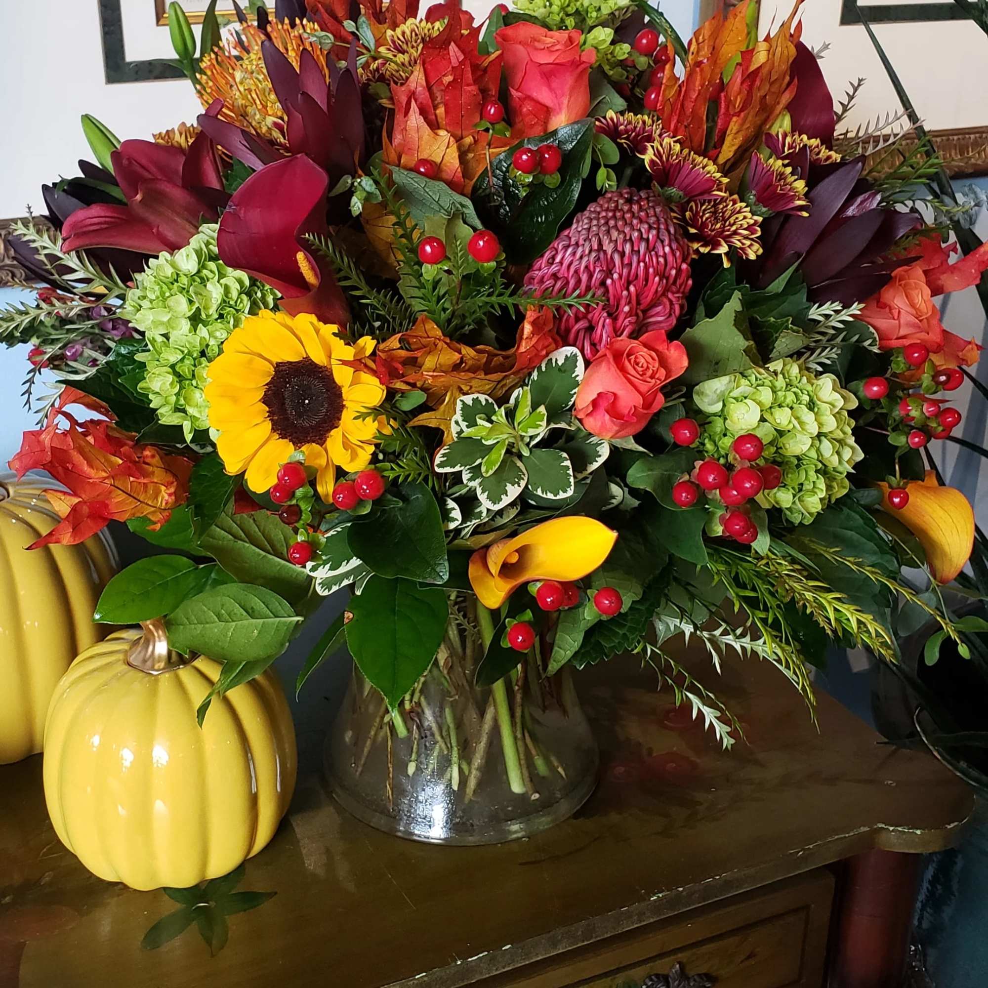  An elegant gathering vase filled with seasonal bright flowers such as