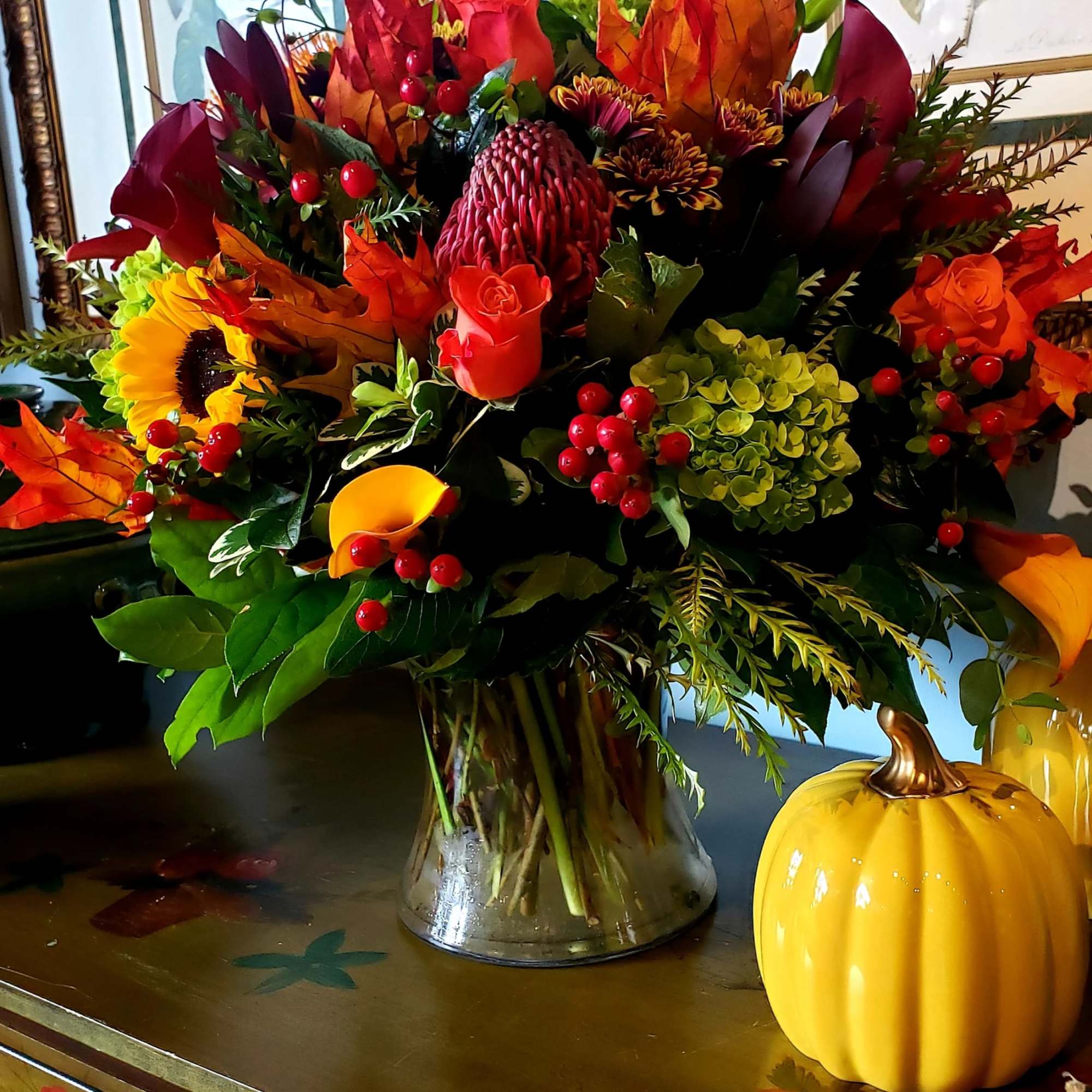  An elegant gathering vase filled with seasonal bright flowers such as